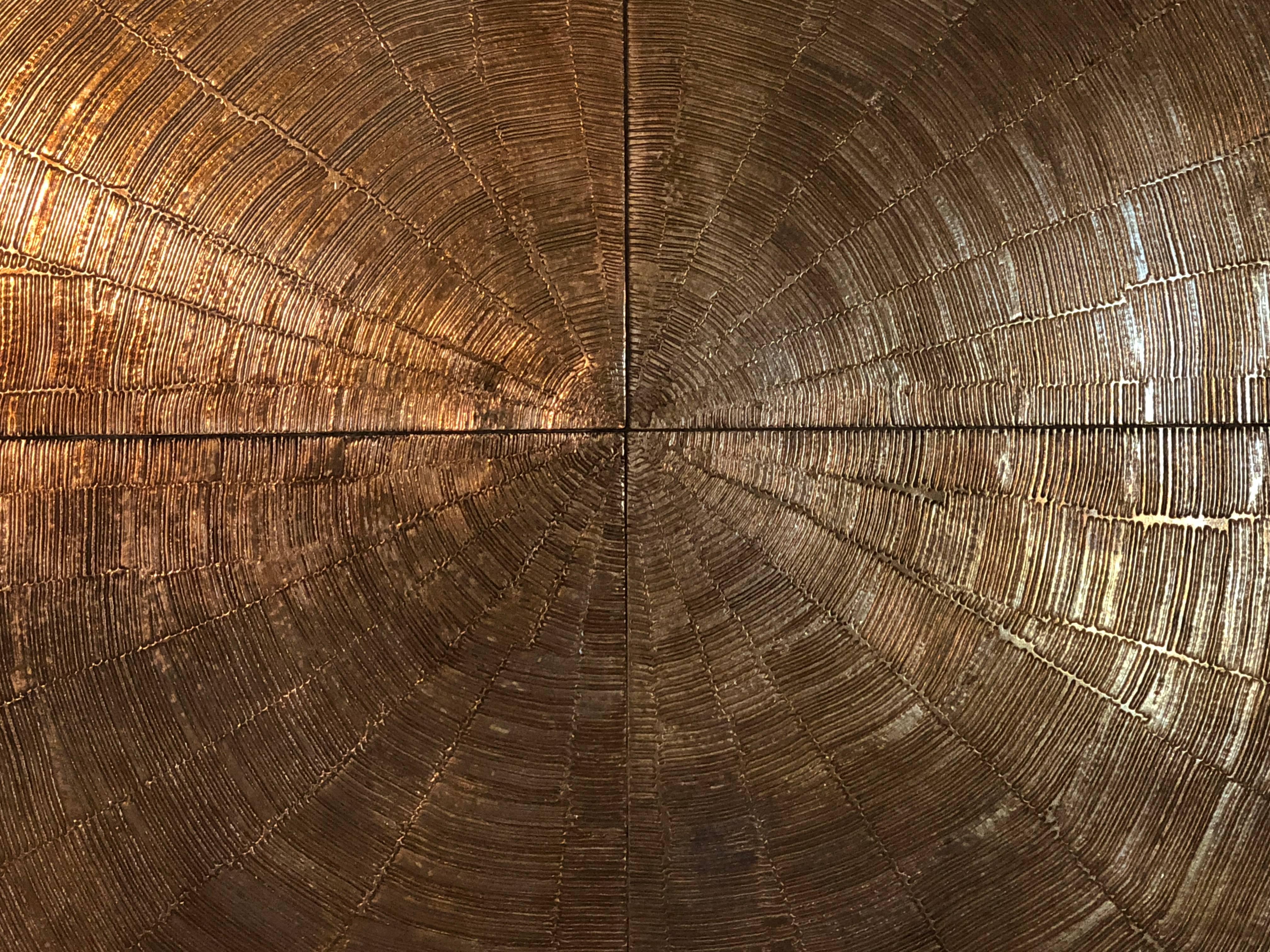 A huge handcrafted etched bronze sunburst table by Georges Mathias. Signed on rim.  Black lacquer pedestal base. One of the largest tables he ever made. This is a luminous color and enhances any object you place on it.