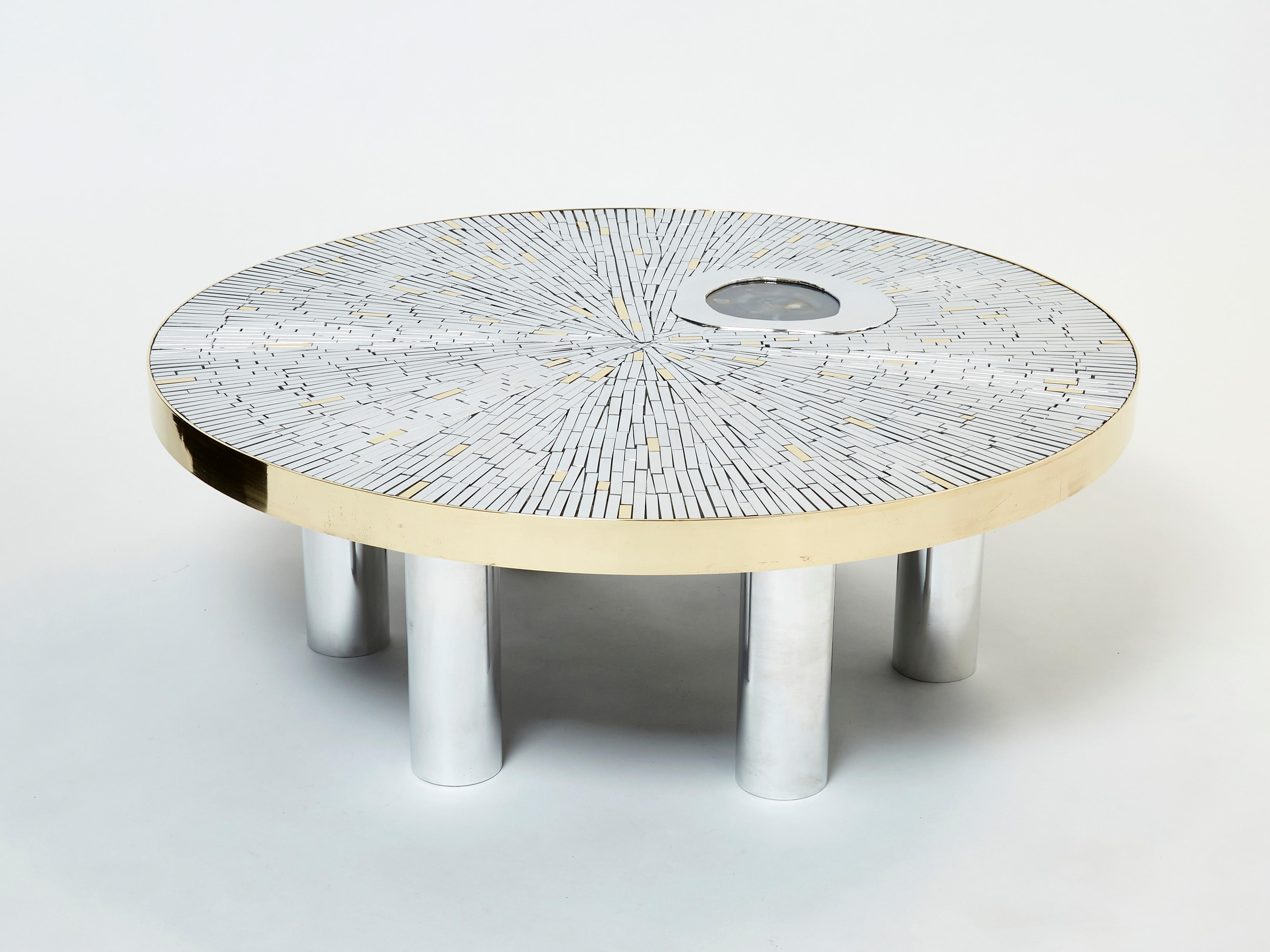 This is a unique round Belgian coffee table signed by Georges Mathias produced in the late 1970s. The table features an amazing mosaic top made of chrome metal and brass rods, with an agate stone inlay, surrounded by a brass strapping, with a chrome