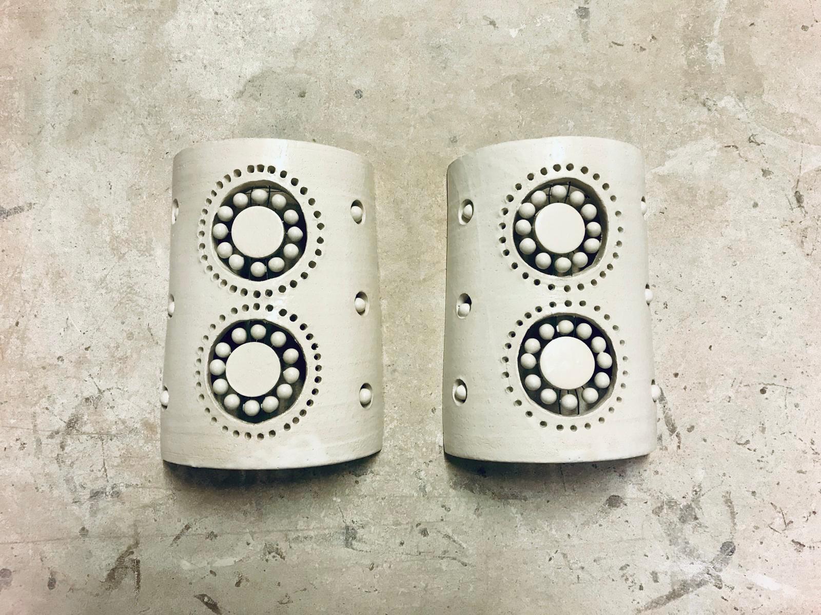 Pair of 2 flowers sconces in white enameled ceramic, as all the Georges Pelletier lamps, this pair of sconces is bringing to your space an amazing light experience when the night falls, and a stunning sculptural presence during the day. Approximate