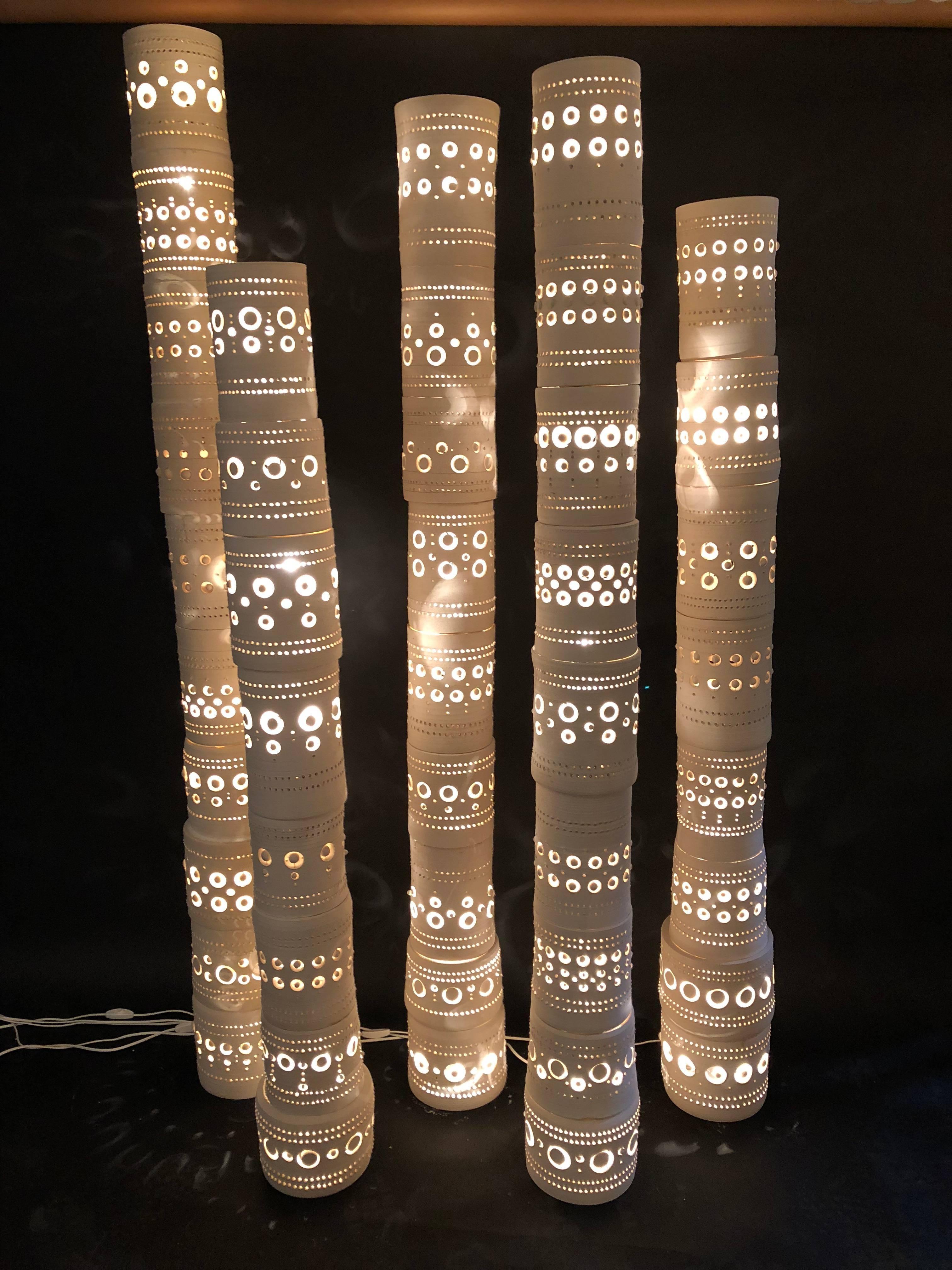 Georges Pelletier,
Set of five TOTEM lights,
Unglazed ceramic, signed,
circa 1970, France.
1/ Height 195 cm, diameter 27 cm (first on the left),
2/ Height 160 cm, diameter 25 cm (second o the left),
3/ Height 185 cm, diameter 20 cm (the one of