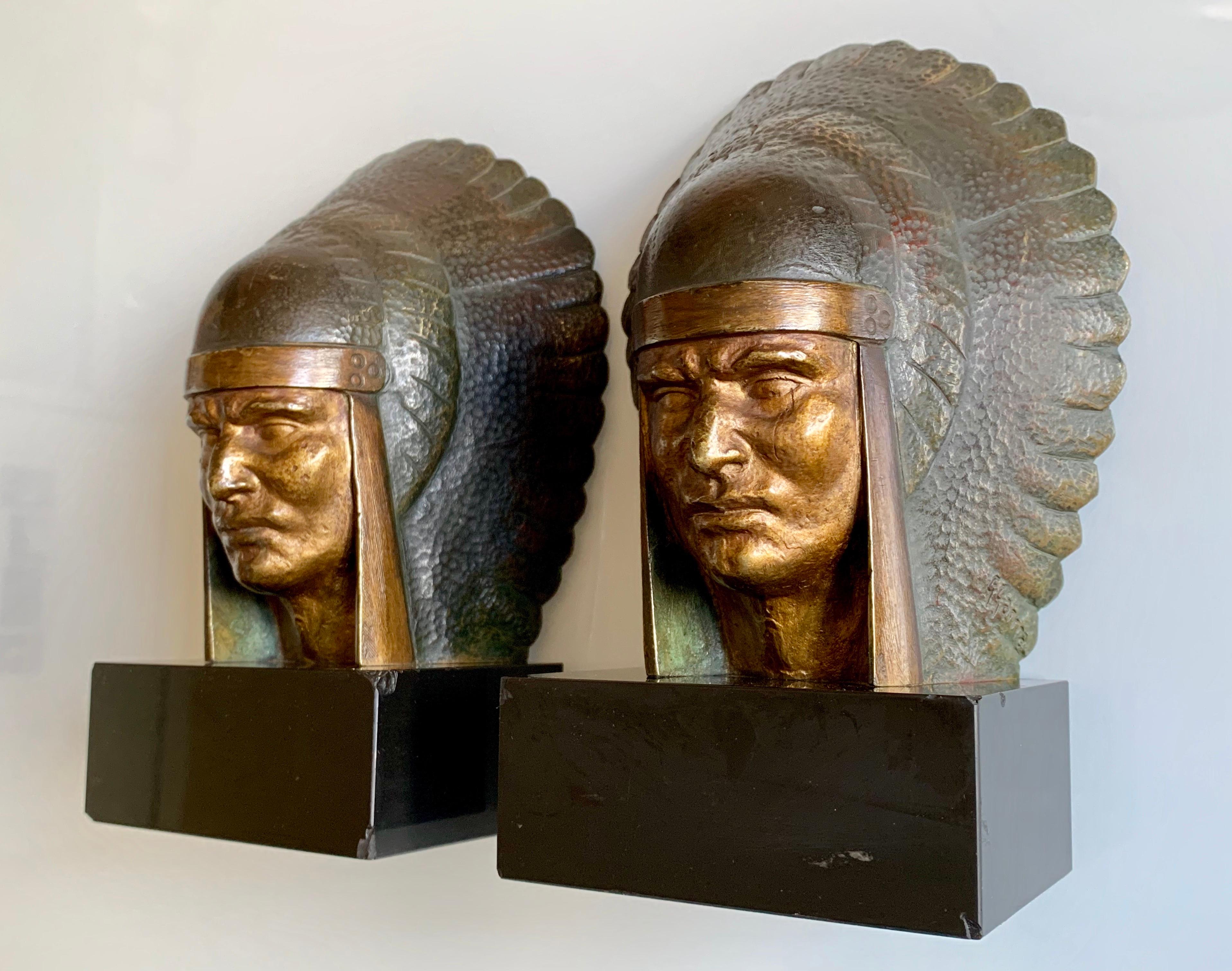 A pair of patinated bronze bookends in the guise of North American Indian chiefs. These sit proudly on black marble bases.