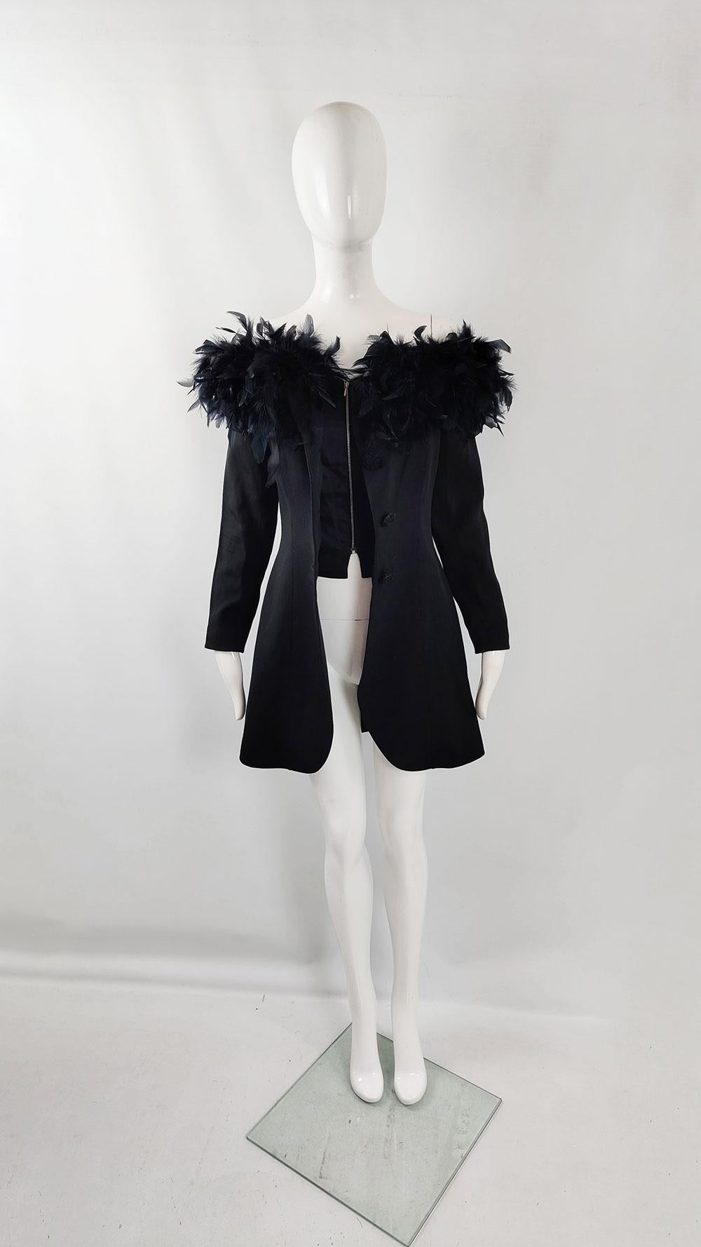 A glam vintage women's jacket from the late 80s/early 90s by French designer Georges Rech. In black acetate wool blend, it flaunts standout buttons, off-shoulder style with dark blue feather trim, and a zip-up inner boned corset.

Size: Marked EU 38