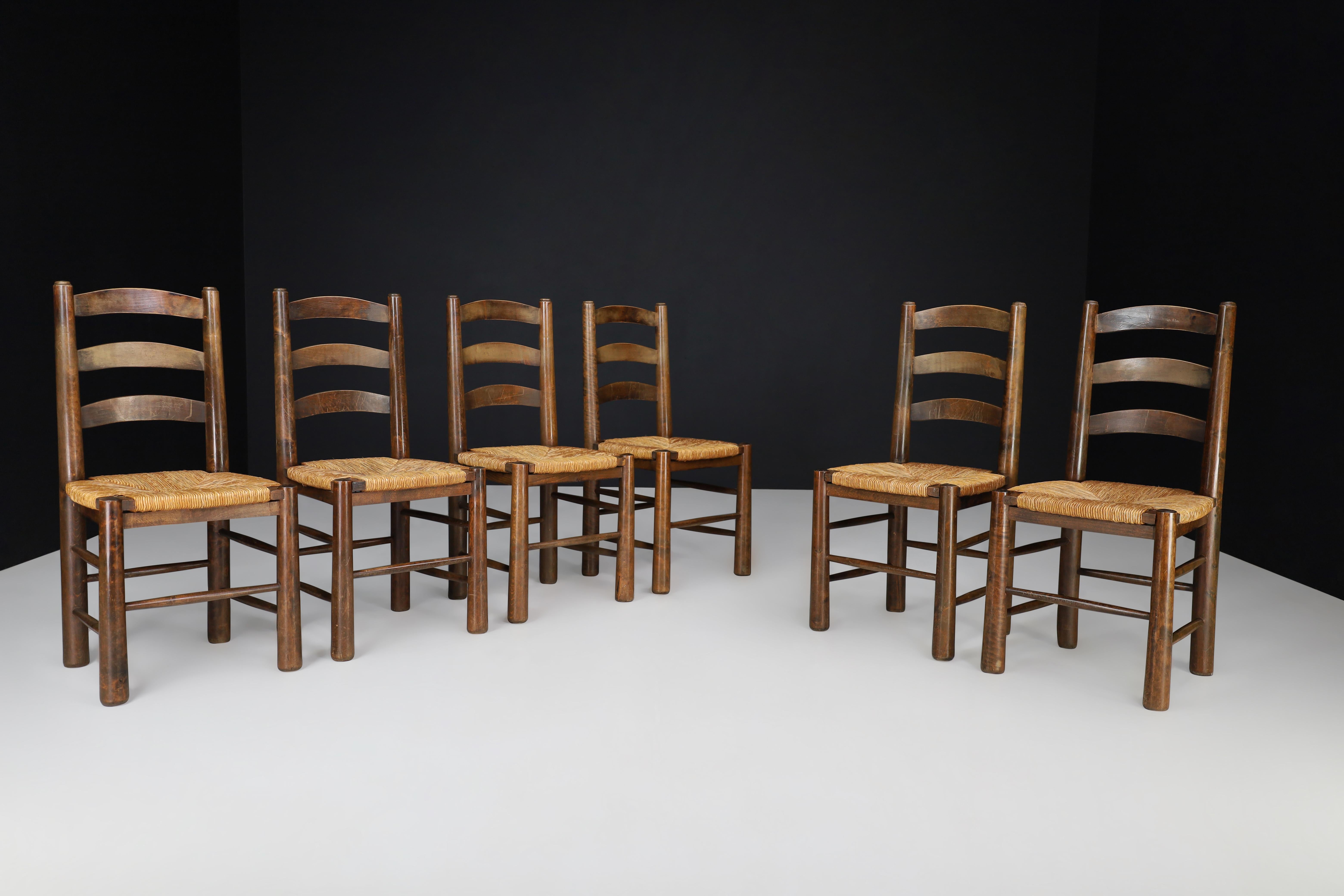 Georges Robert dining chairs in oak and rush, France 1950s.

These are six chairs from the 1950s, made by a French cabinetmaker named Meubles Georges Robert. They are perfect for a mountain or chalet setting and have a solid oak structure with