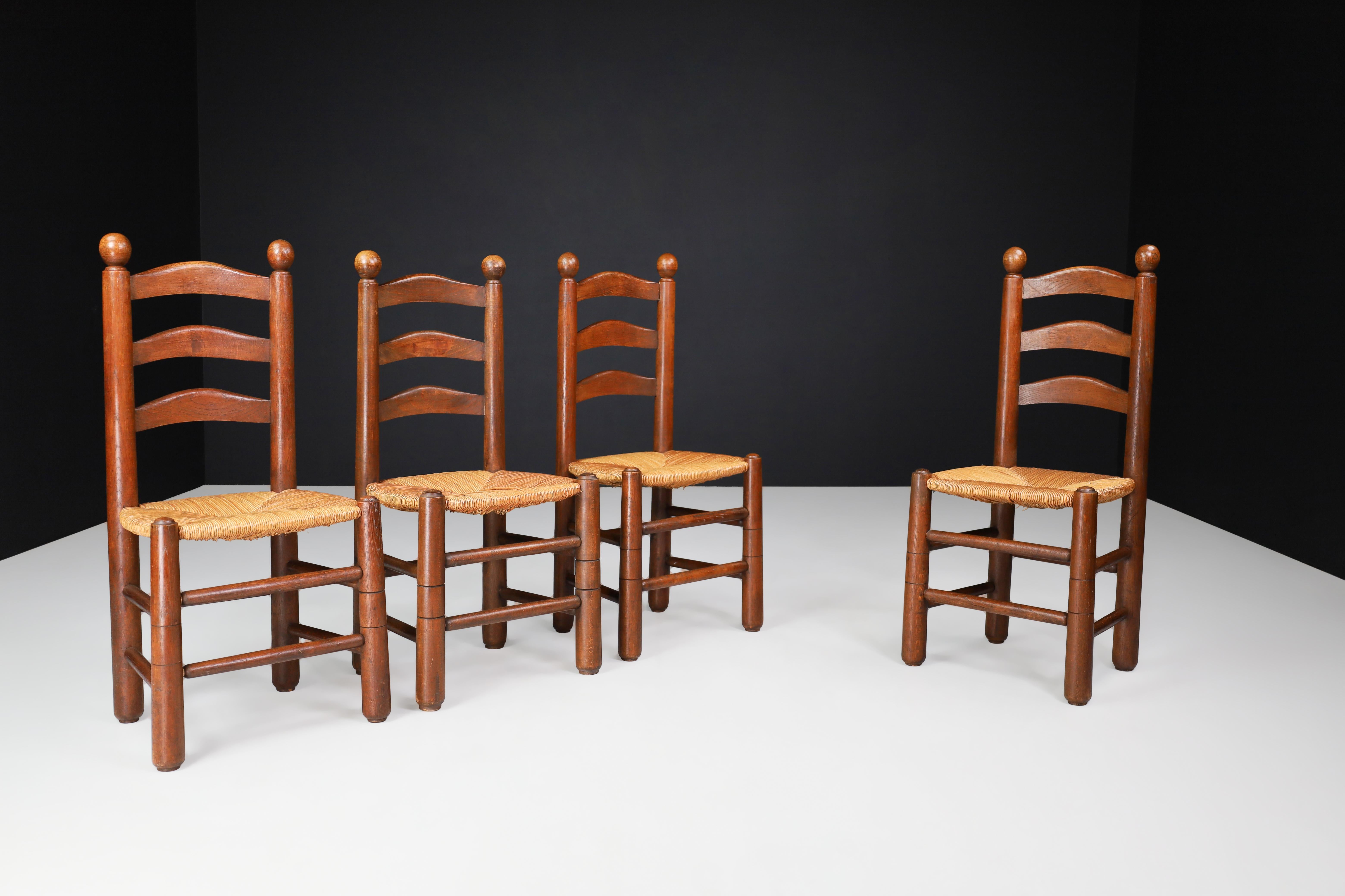Georges Robert dining chairs in oak and rush, France 1950s.

Enhance the charm of your mountain or chalet setting with these exquisite chalet chairs crafted in the 1950s by French cabinetmaker Meubles Georges Robert. These chairs are a beautiful