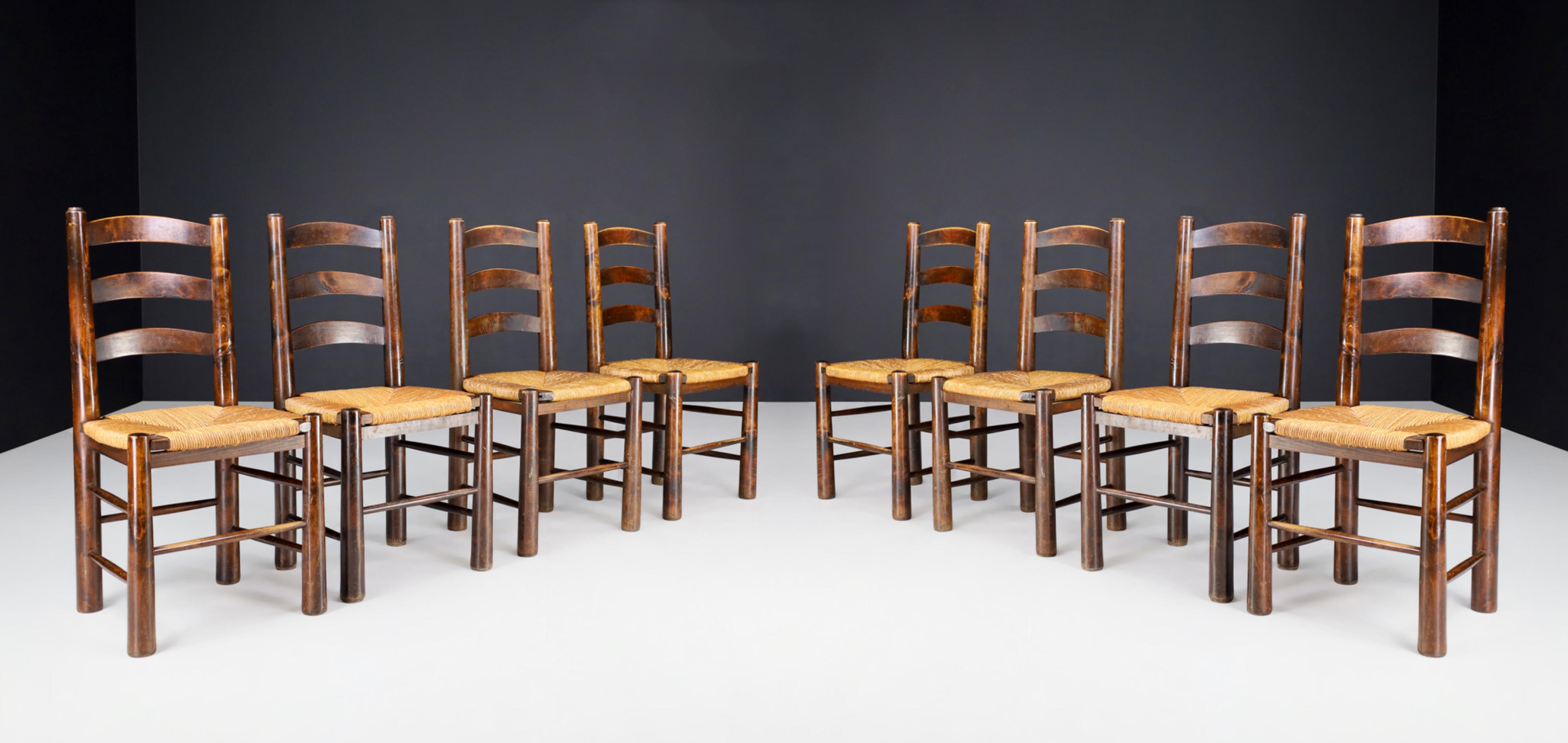 Georges Robert dining chairs in patinated oak and rush, France 1950s

Set of 8 Mountain or chalet chairs made by Meubles Georges Robert french cabinetmaker in the 1950s. The structure is of solid oak with conical legs. The seat is woven rush,