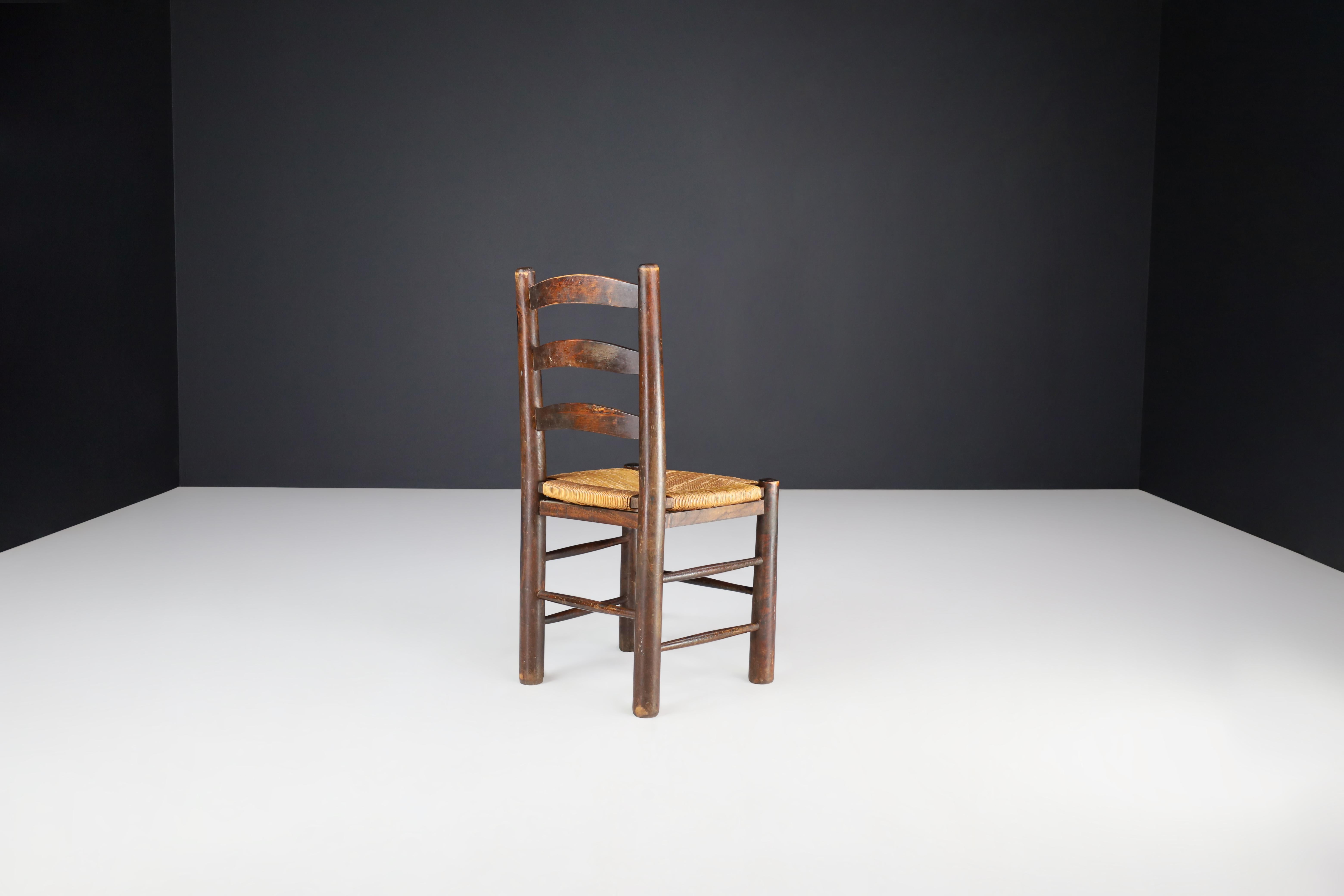 French Georges Robert Dining Chairs in Patinated Oak and Rush, France, 1950s For Sale