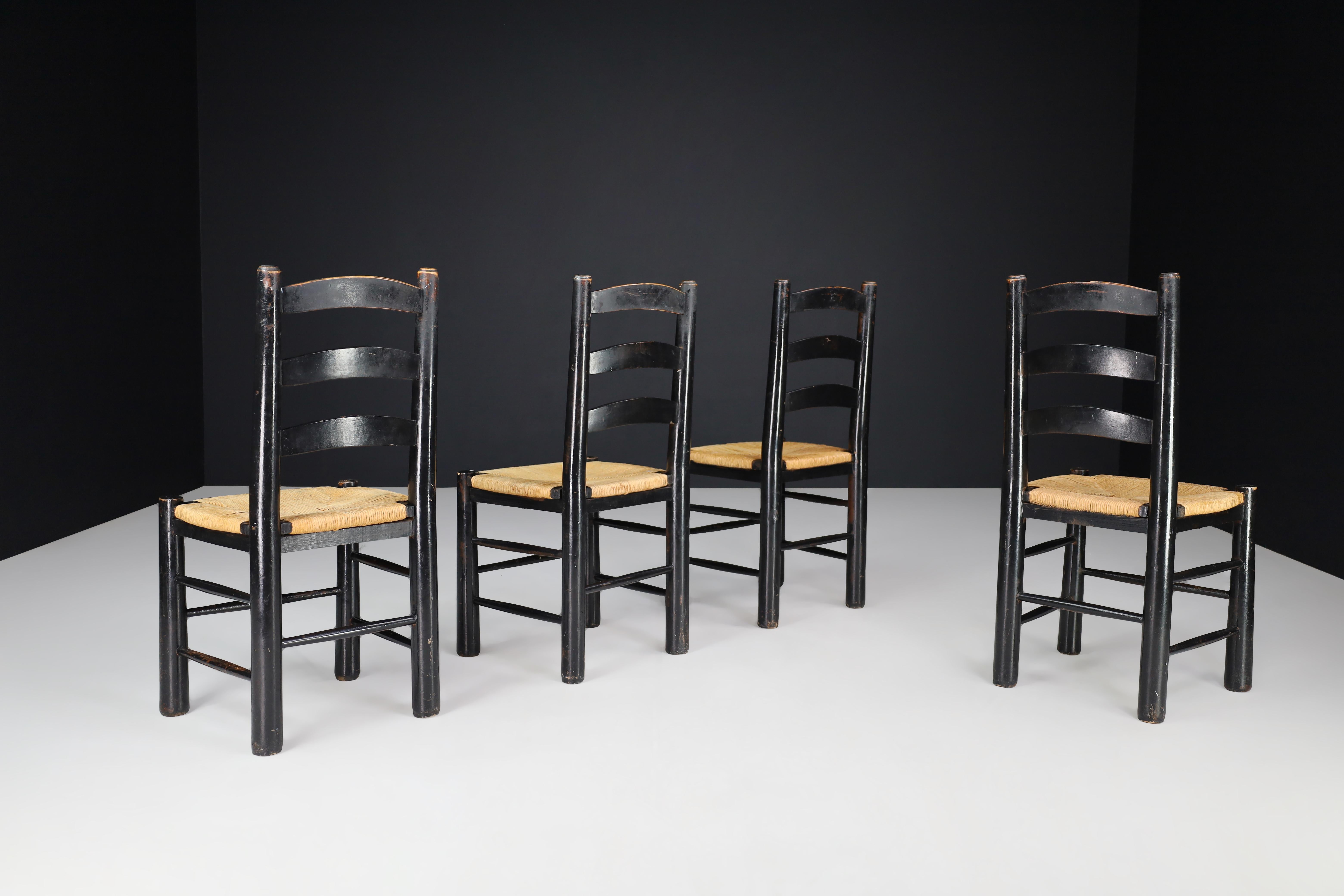 Brutalist Georges Robert Patinated Chairs in Oak and Rush, France, 1950s For Sale