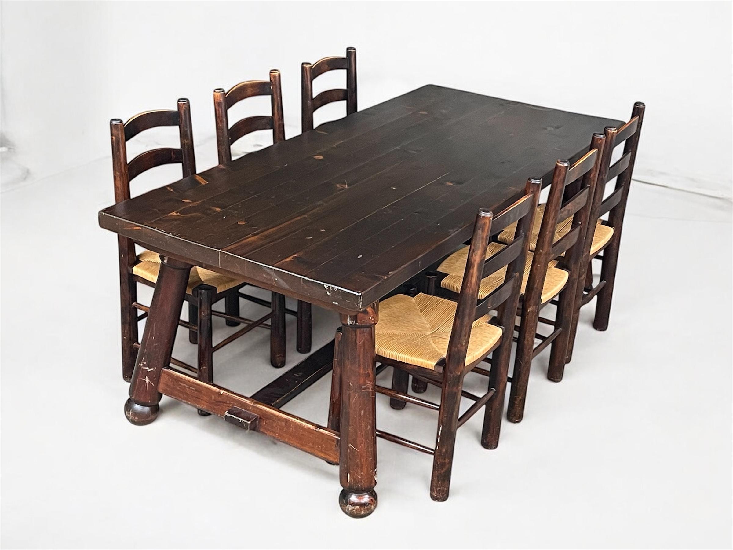 Exceptional dining set by French designer Georges Robert, consisting of a solid wood table and six sculptural chairs designed in a brutalist mountain style reminiscent of Alpine chalet furniture.

The standout feature of this set lies in the chairs’
