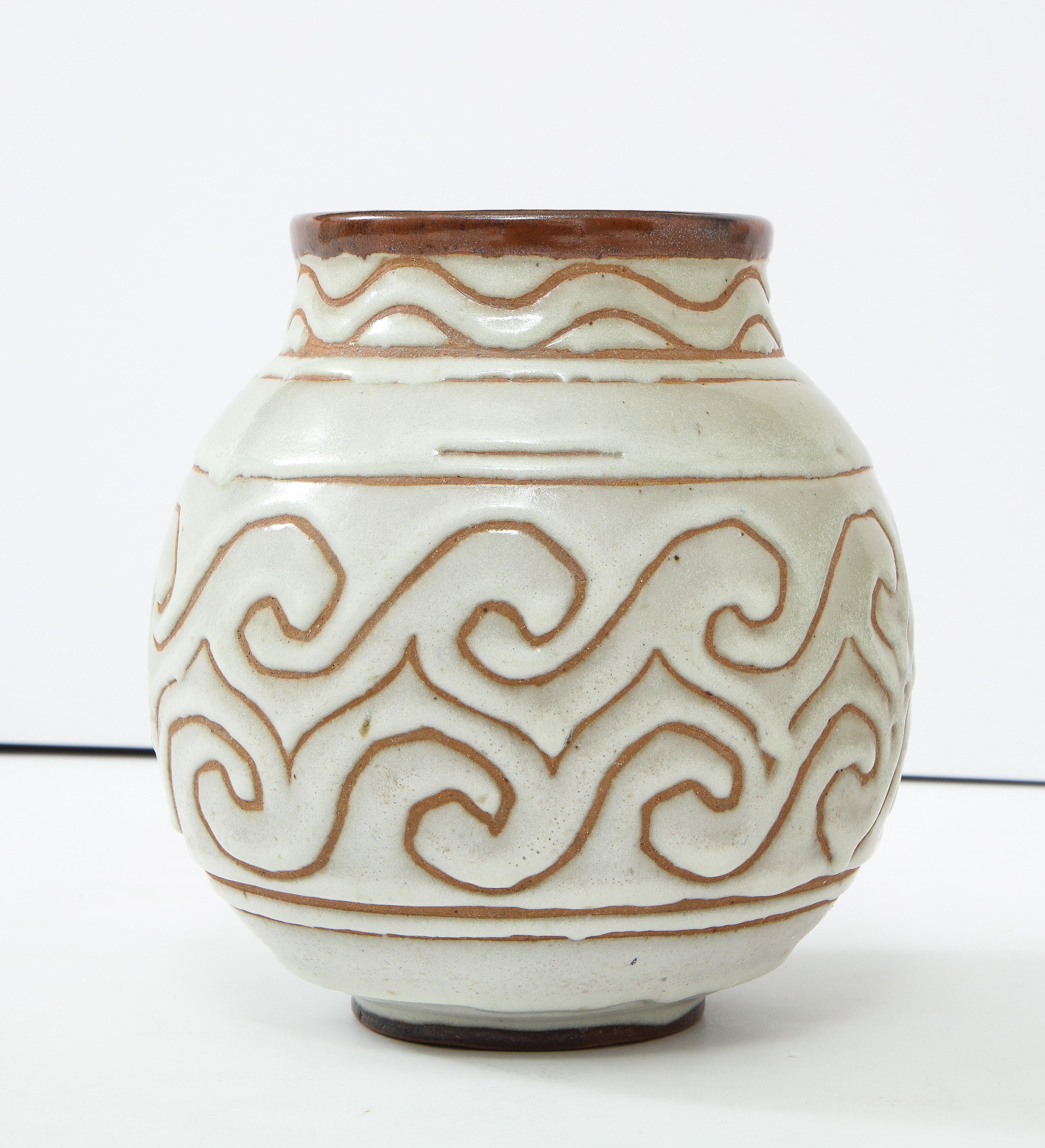 Georges Serré (1889-1956) Art Deco ceramic white/celadon enamel ball shaped vase with wide neck, France, circa 1930, signed

Repeating wave pattern & glaze drips
Measures: Height 8.75, diameter 8.5 in.

Georges Serré references:

La Céramique