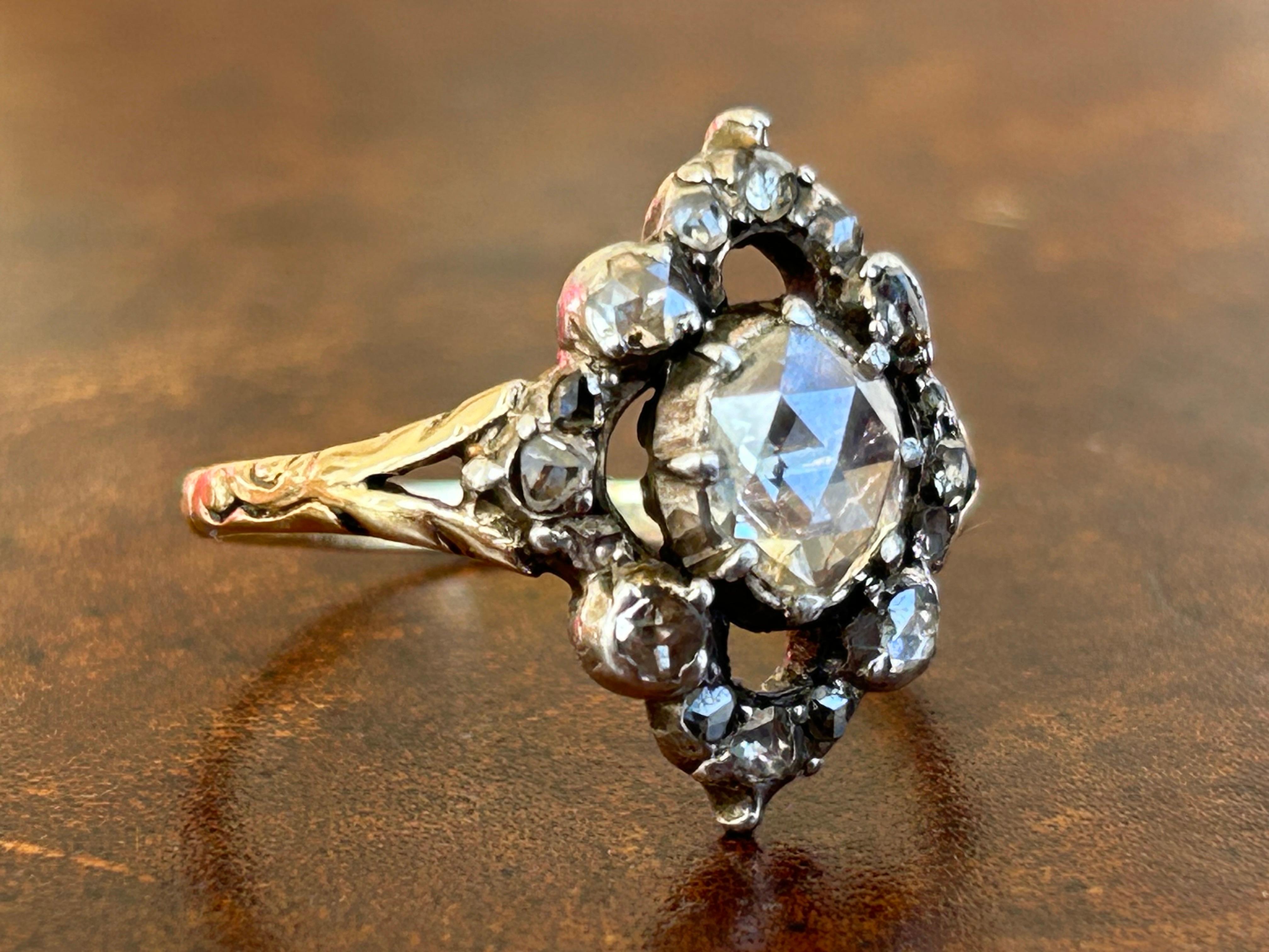 An Antique Georgian Dome Rose Cut Diamond Ring. Boasting a splendid center stone that captures the essence of the Georgian period's sophistication, this 8 mm in length, 7 mm wide, and 3.75 mm deep diamond is meticulously Colette set within a closed