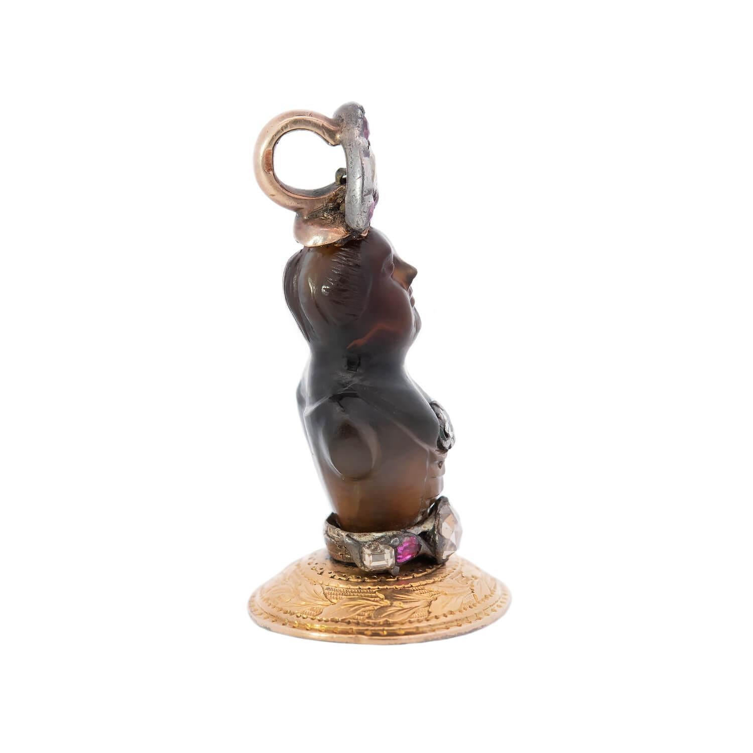 A fantastic pendant from the Georgian era (ca1830)!  Made of vibrant 14k yellow gold and carved agate, the pendant has a wonderful 3-dimensional design and depicts the bust of a man. The agate bust has carvings which represent the figure's face,