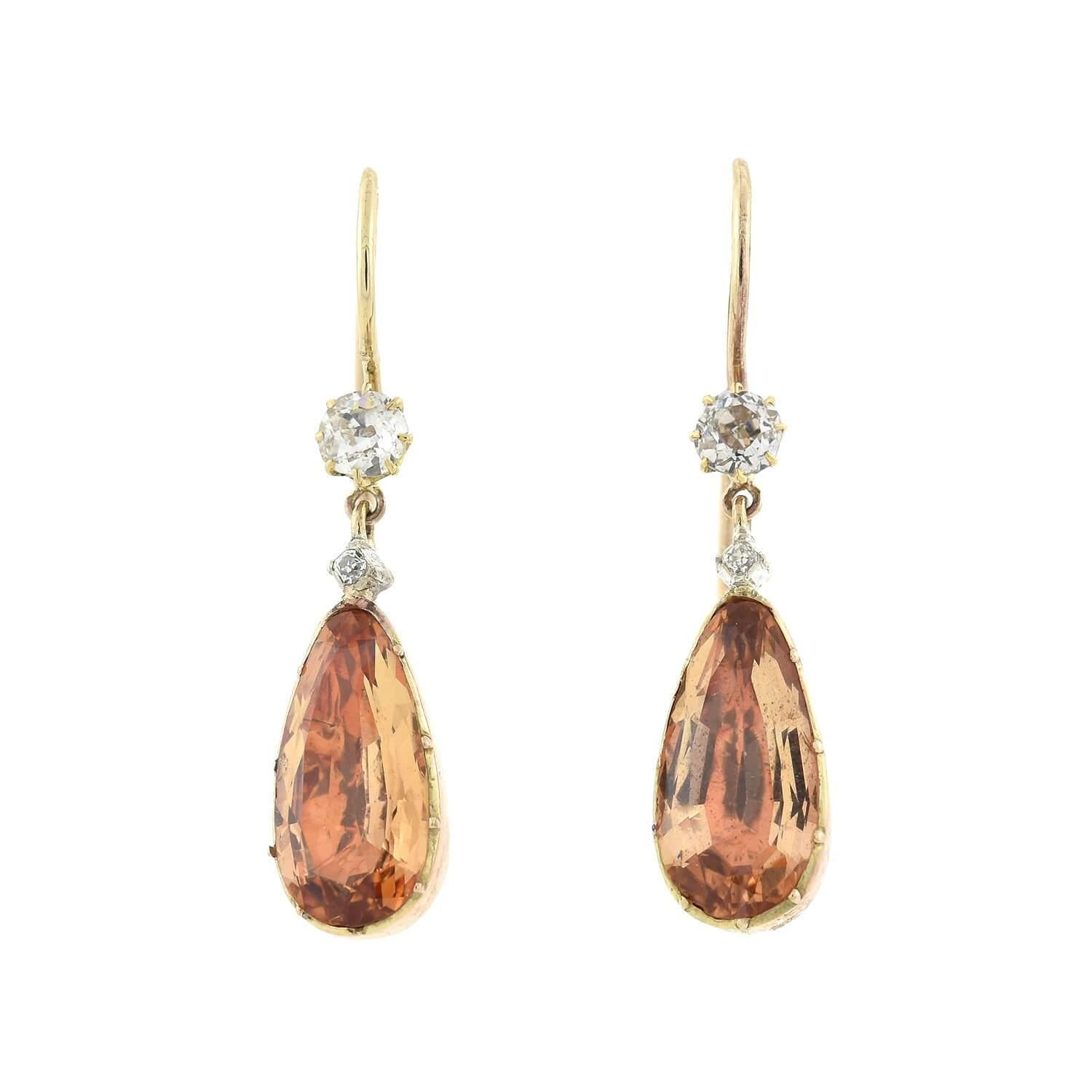 A gorgeous pendant and earring set from the Georgian (ca1750s) era! Crafted in 14kt yellow gold, the earrings and pendant have a gorgeous pear-shaped Imperial Topaz stone within a closed-back collet setting. A Rose Cut diamond tops each of the