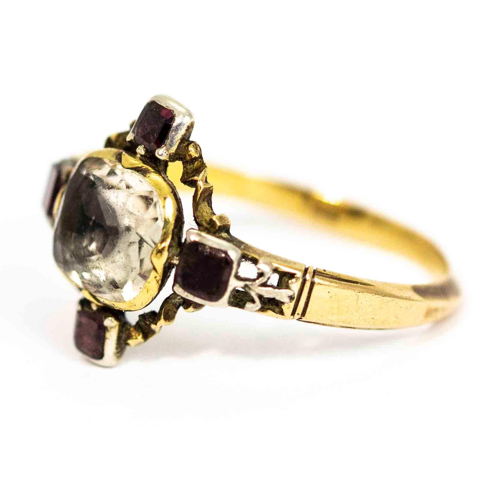 A spectacular antique Georgian ring. Centred with a wonderful chrysoprase bordered on all sized by beautiful flat cut garnets. The garnets are joined in superb ornate gallery between elegant open work shoulders. Modelled in 15 carat yellow gold.

