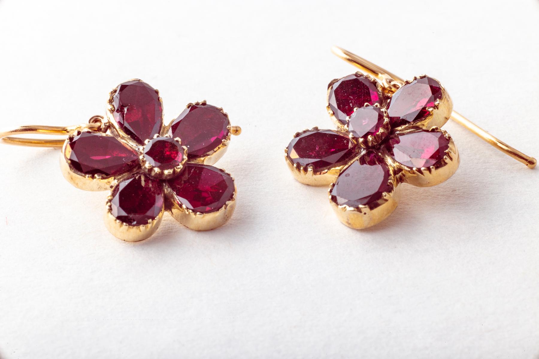 A touch of Georgian garnet color comes to you with these drop earrings from the Georgian era. c. 1820. The are set in 15 kt gold with closed foiled garnets. They would have been daytime jewelry in the Georgian era. Comfortable of course at a