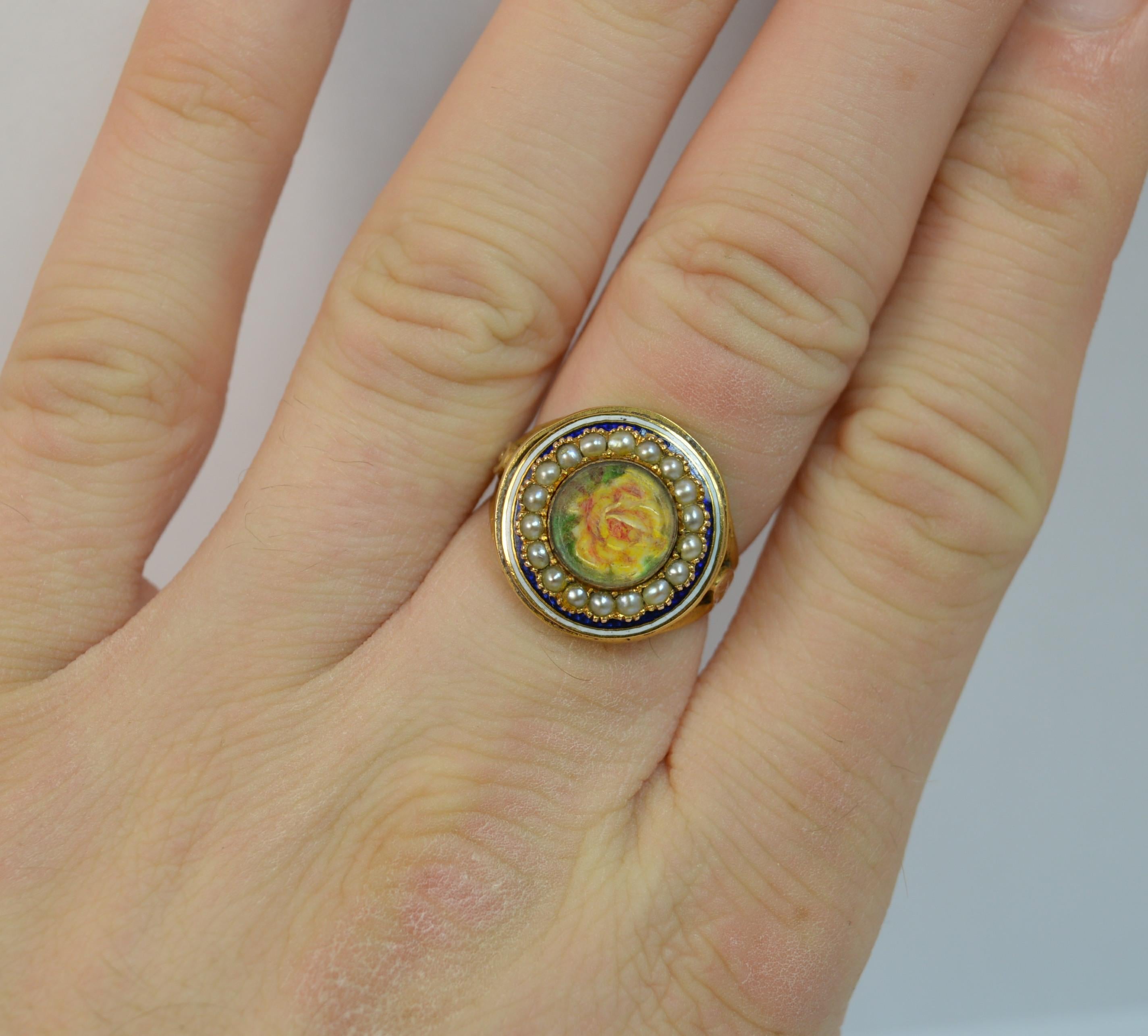 A superb George III period cluster ring.
SIZE ; M 1/2 UK, 6 1/2 US
Sold 15 carat yellow gold ring.

Designed with a rose to the centre, seed pearl surround and blue and white enamelling. 15mm diameter head.


CONDITION ; Good for age. Clean shank,