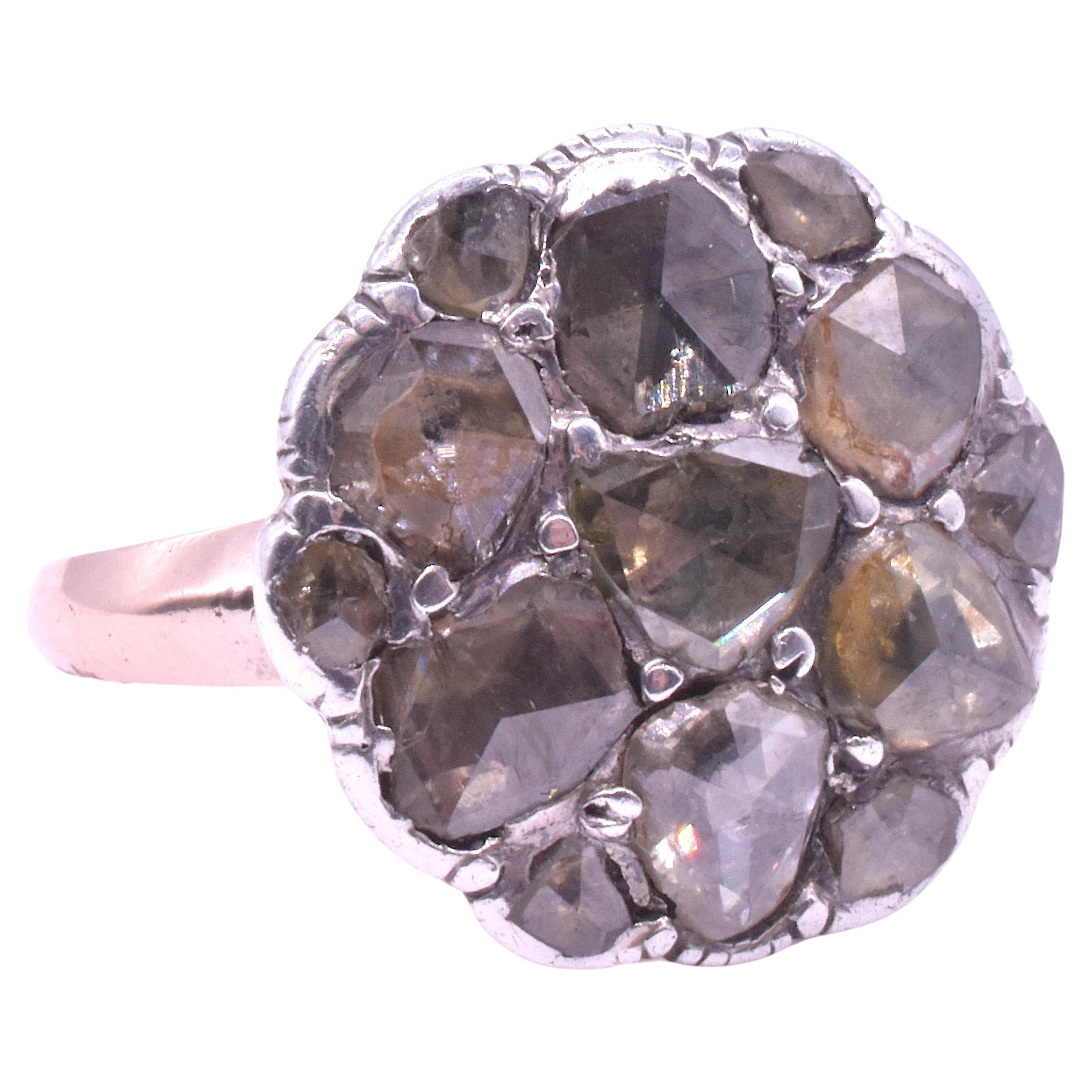 15K Rare Georgian diamond cluster ring consisting of 6  large stones cut en cabochon (no facets and polished smooth) set radially about a large center diamond.  Six smaller stones are set along the border. The border is crimped, a feature of hand