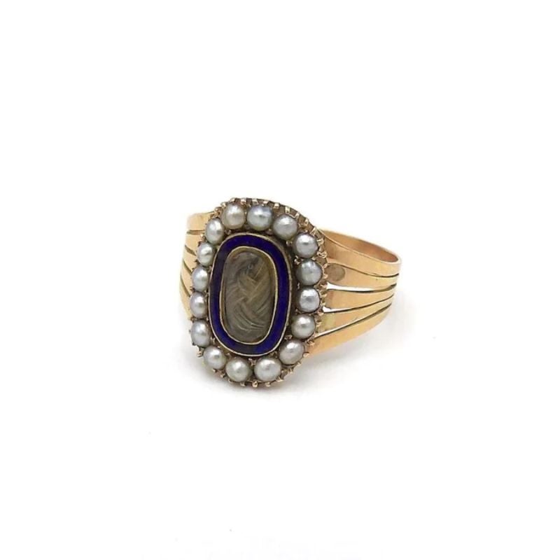 This is an incredible 15k gold, seed pearl, cobalt blue enamel, and hair mourning ring from the Georgian era. Hair jewelry became a fashionable mourning practice in the 19th Century. It was a way to hold a piece of the departed love one close and