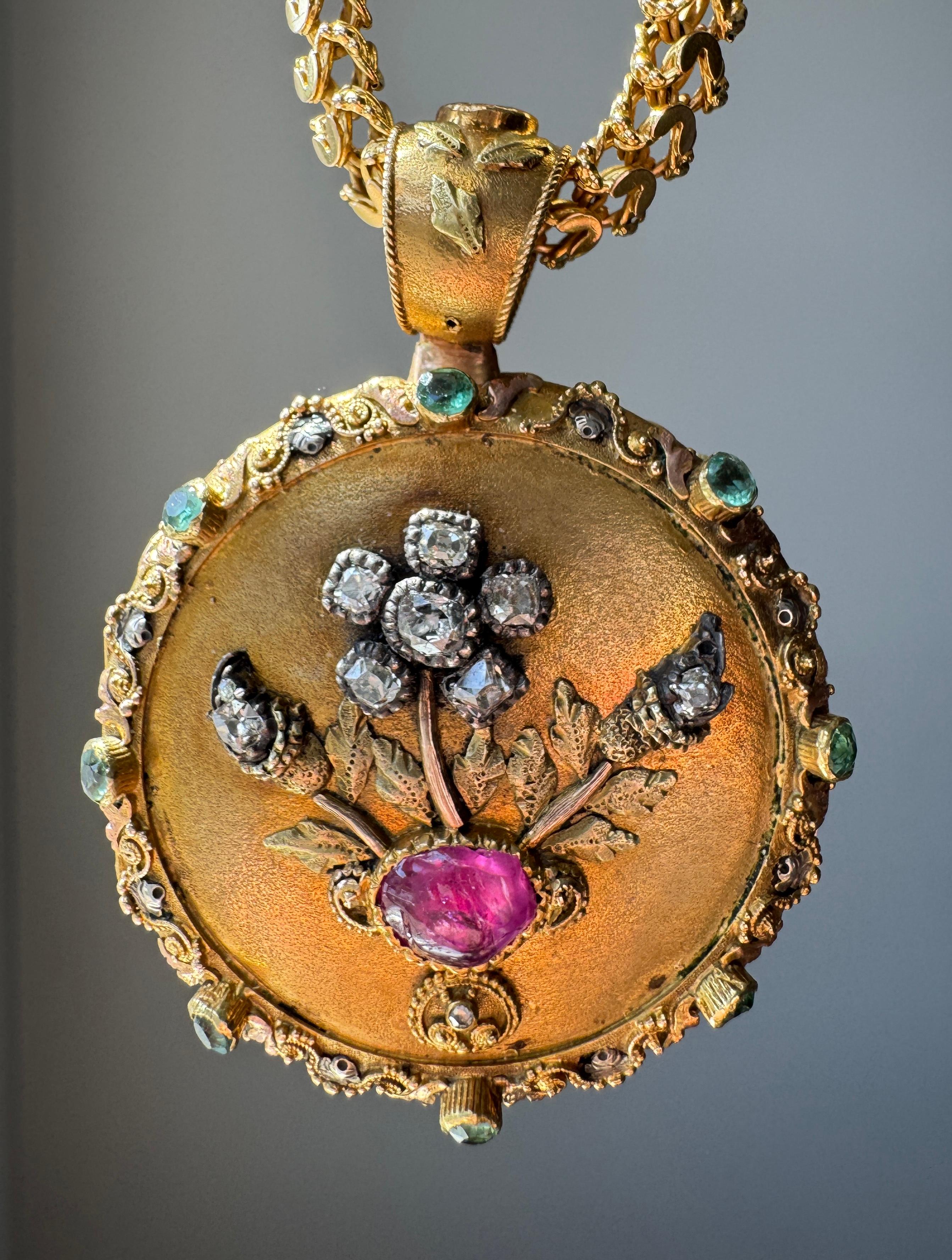 A rare and opulent example of Georgian artistry, this vinaigrette is masterfully handcrafted in 15 karat rose, green and yellow gold. It is lavishly adorned with sparkling diamonds, a vivid ruby, and glowing emeralds. The front showcases a