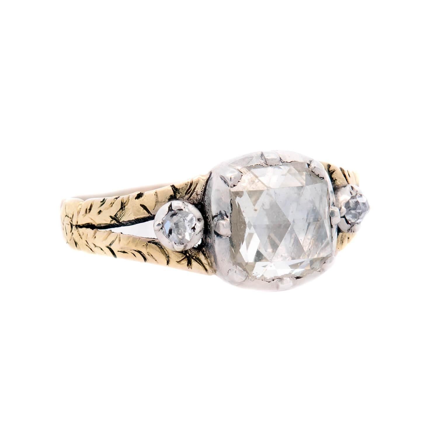 A gorgeous diamond ring from the Georgian (ca1750s) era! Crafted in 15k yellow gold and sterling silver, this ring features 3 diamonds running horizontally across the ring's front surface. The central, larger stone is a rose cut diamond, which rests