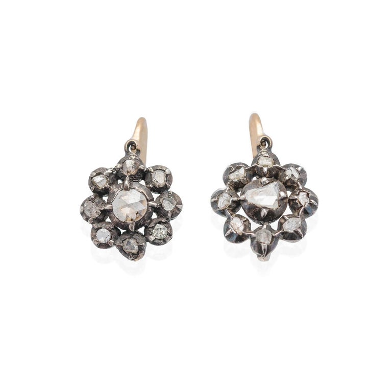 A magnificent pair of Day-to-Night earrings from the Georgian (ca1750s) era! Crafted in 15kt yellow gold and topped in sterling silver, these incredible earrings begin with an elegant floral cluster of 9 Rose Cut diamonds in patinaed collet