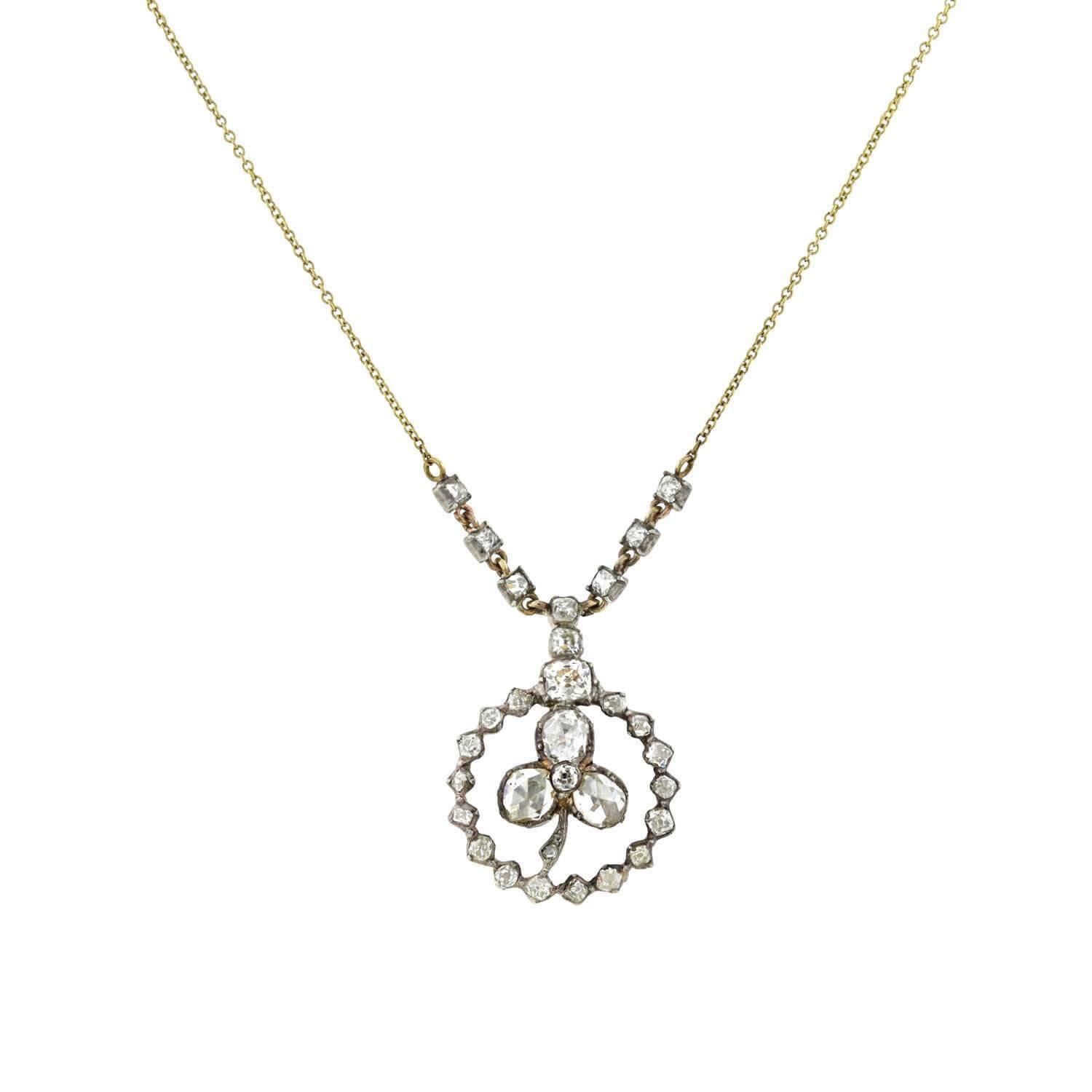 A breathtaking diamond pendant necklace from the Georgian (ca1750) era! Crafted in 15kt rose gold topped with sterling silver, this lovely foil-backed diamond trefoil graces the center of the pendant, encircled by a sparkling diamond border. A trio