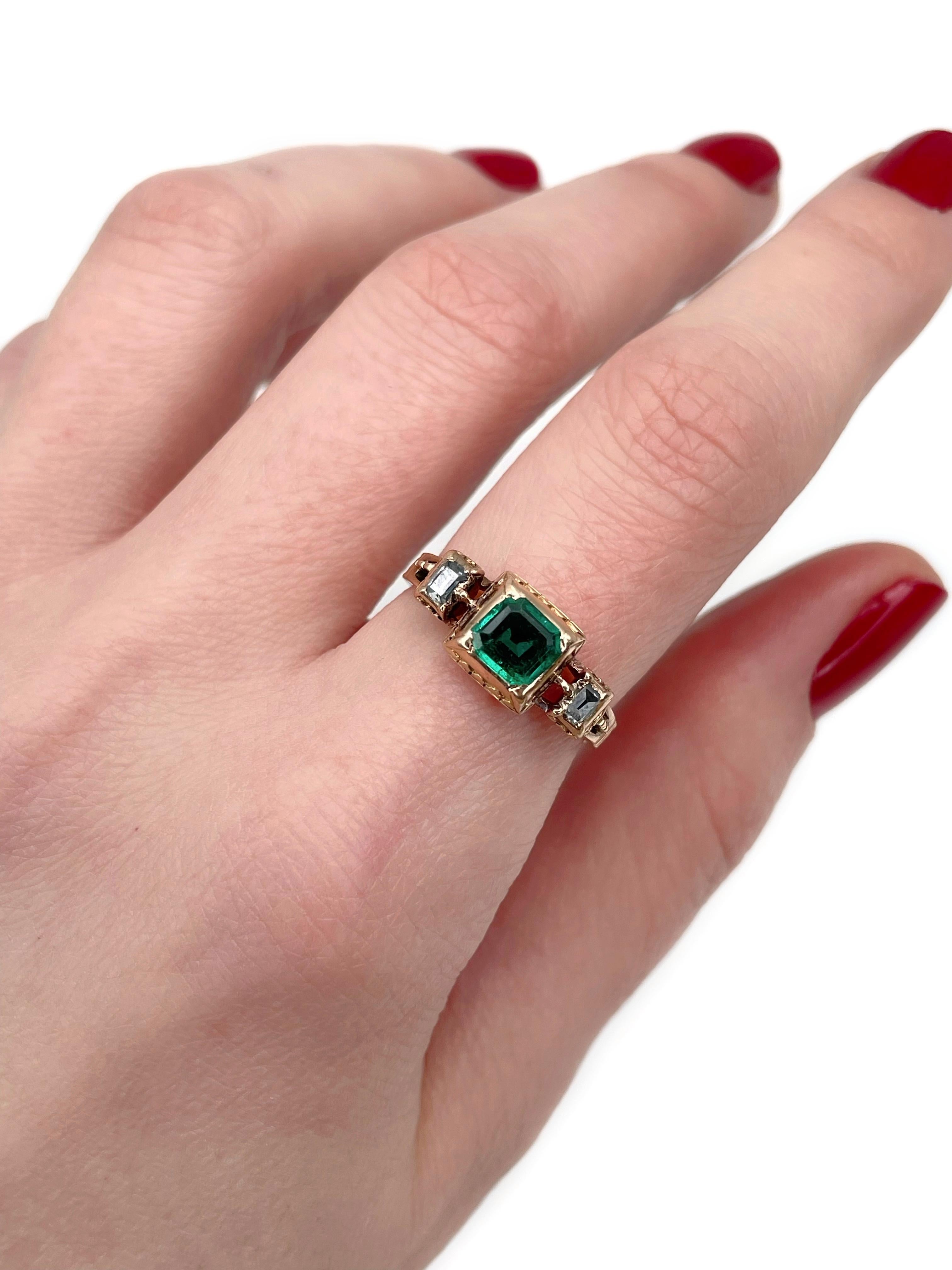 This is an amazing Georgian three-stone ring crafted in 18K gold. Circa 1830. 

The piece features:
- 1 emerald, emerald cut, 1.50ct, vslbG 5/4, SI
- 2 diamonds, table cut, TW 0.18ct, W (Grey), SI-P1

Has an inscription (see the photo
