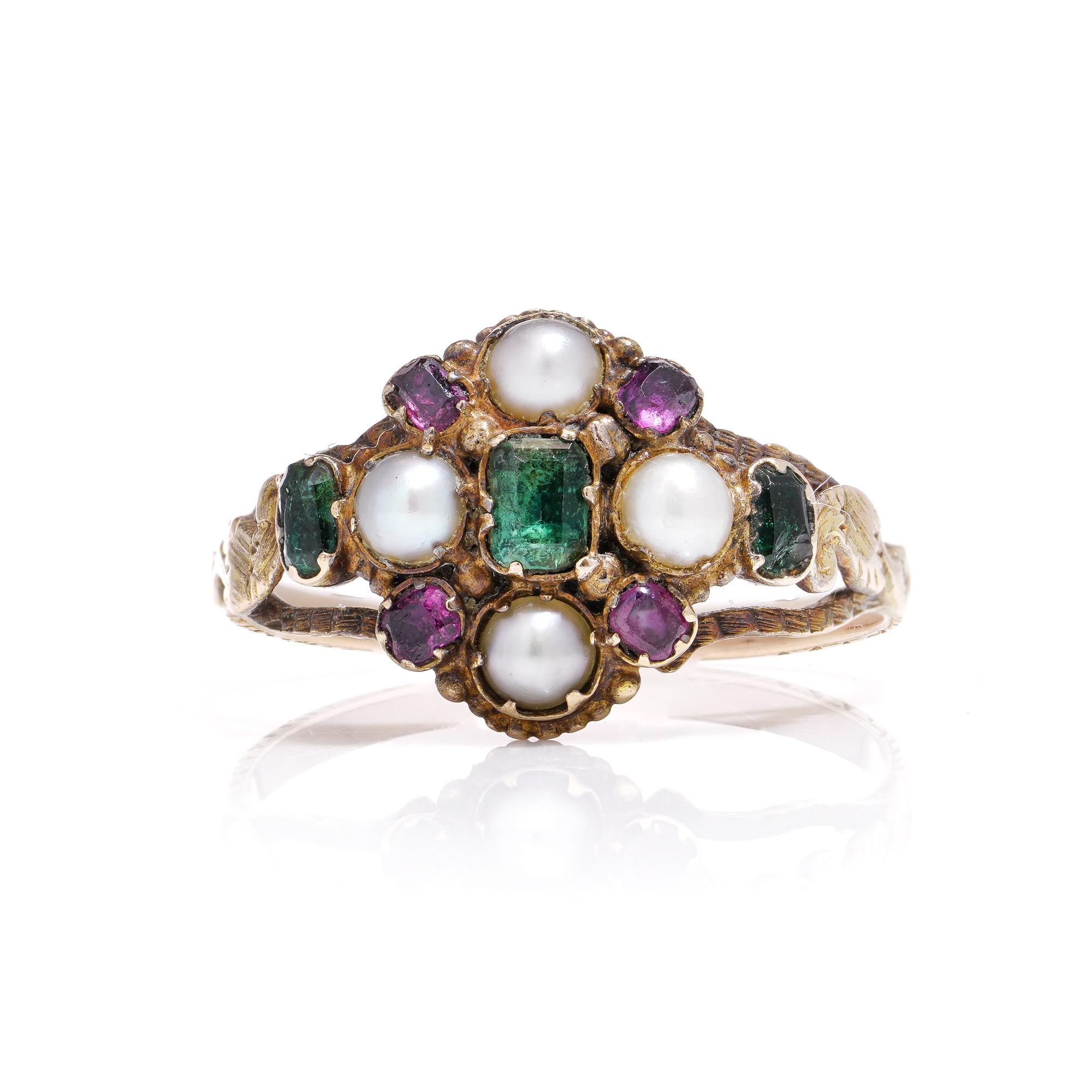 Dating back to around 1810 in England, this 18kt yellow gold cluster ring captures the essence of the Georgian era with its captivating charm. Adorned with emeralds, rubies, and pearls, its intricate design is a testament to the era's craftsmanship.