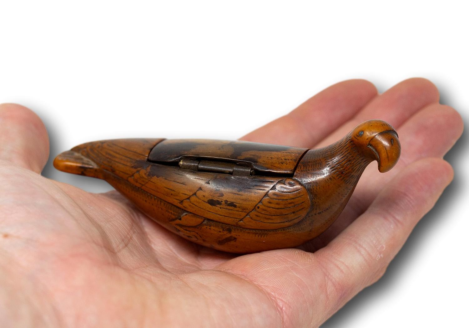 Fruitwood Snuffbox in the Shape of a Bird 18th Century George III Period 

The snuff box beautifully formed in the shape of a bird with big round beak simulated feathers and feet tucked under the base of the snuff box. The box with visible