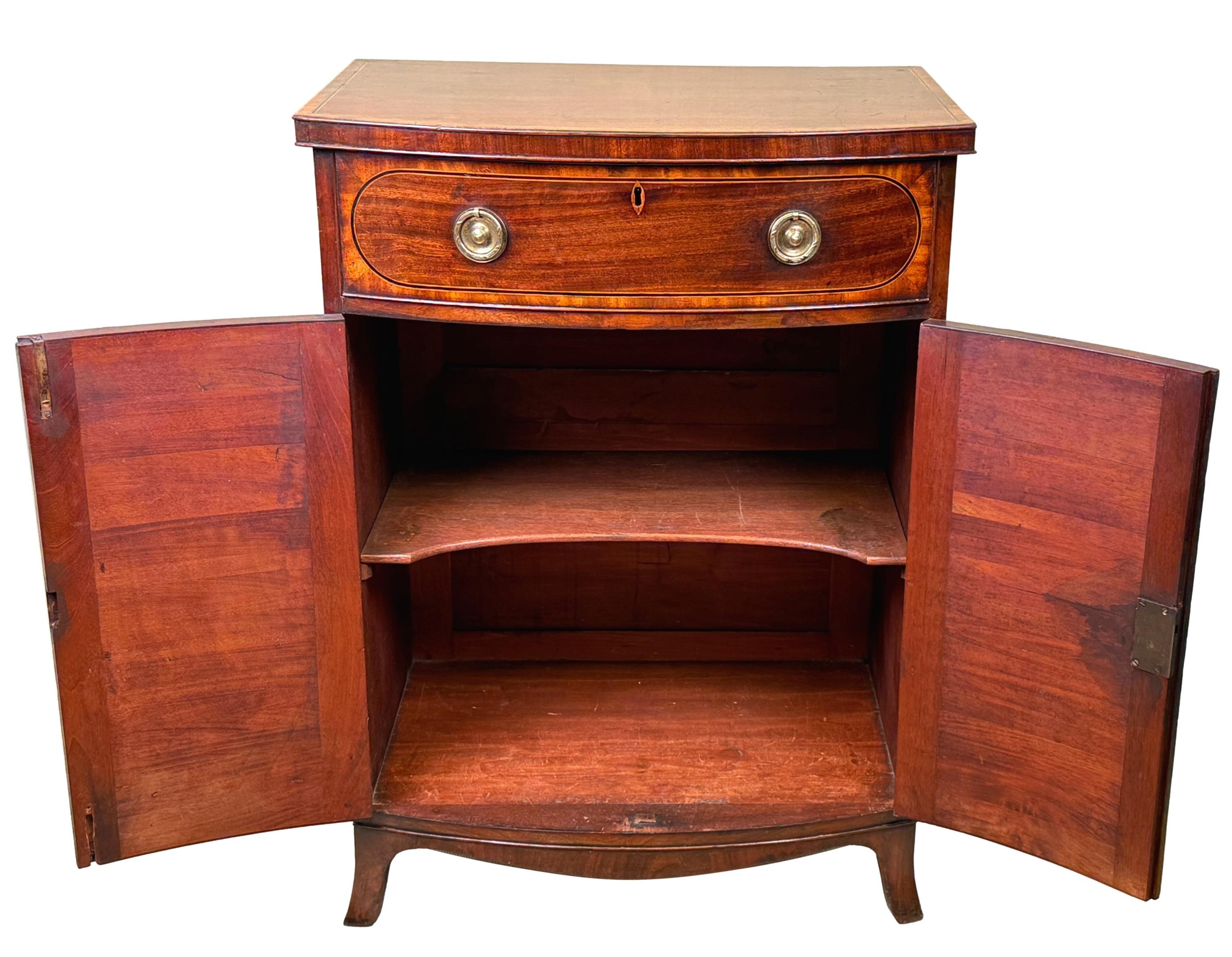 A Very Good Quality Late 18th Century George III Period Mahogany Bowfronted Side Cupboard, Of Rare Small Proportions, Having Crossbanded Top Over One Drawer And Two Panelled Cupboard Doors With Satinwood Crossbanded Decoration Raised On Elegant