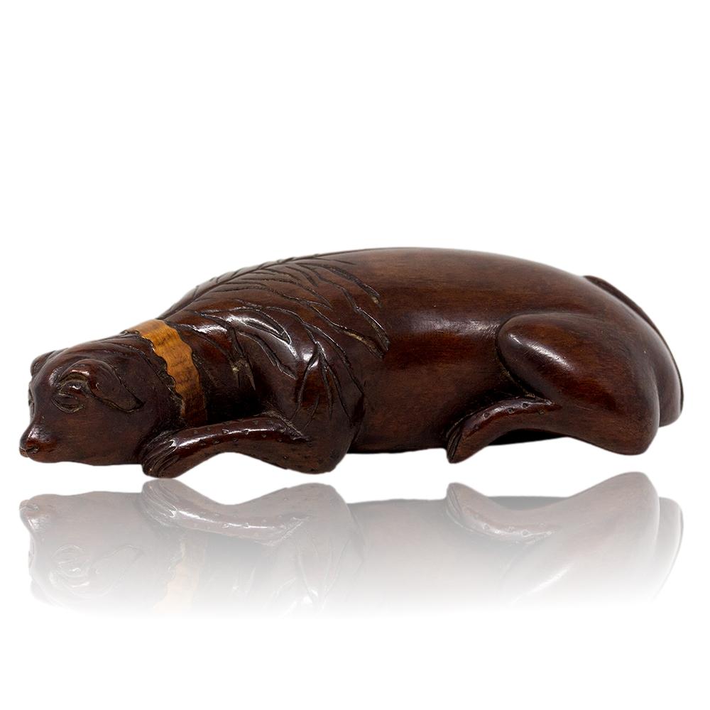 18th Century George III Period 

From our collectables, we are delighted to offer this boxwood Georgian recumbent Dog Snuff Box. The snuff box beautifully formed in the shape of a naive dog laying recumbent with its head on the ground and tail laid