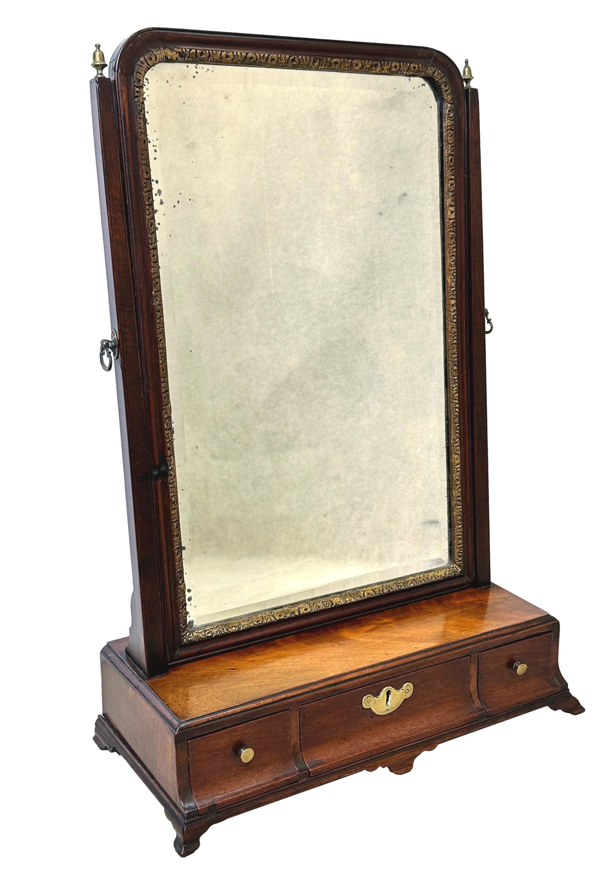A very good quality, 18th century, George II period mahogany dressing table mirror, having old rectangular plate set within gilded slip to elegant moulded frame, over well figured base with three frieze drawers, raised on elegant replacement shaped