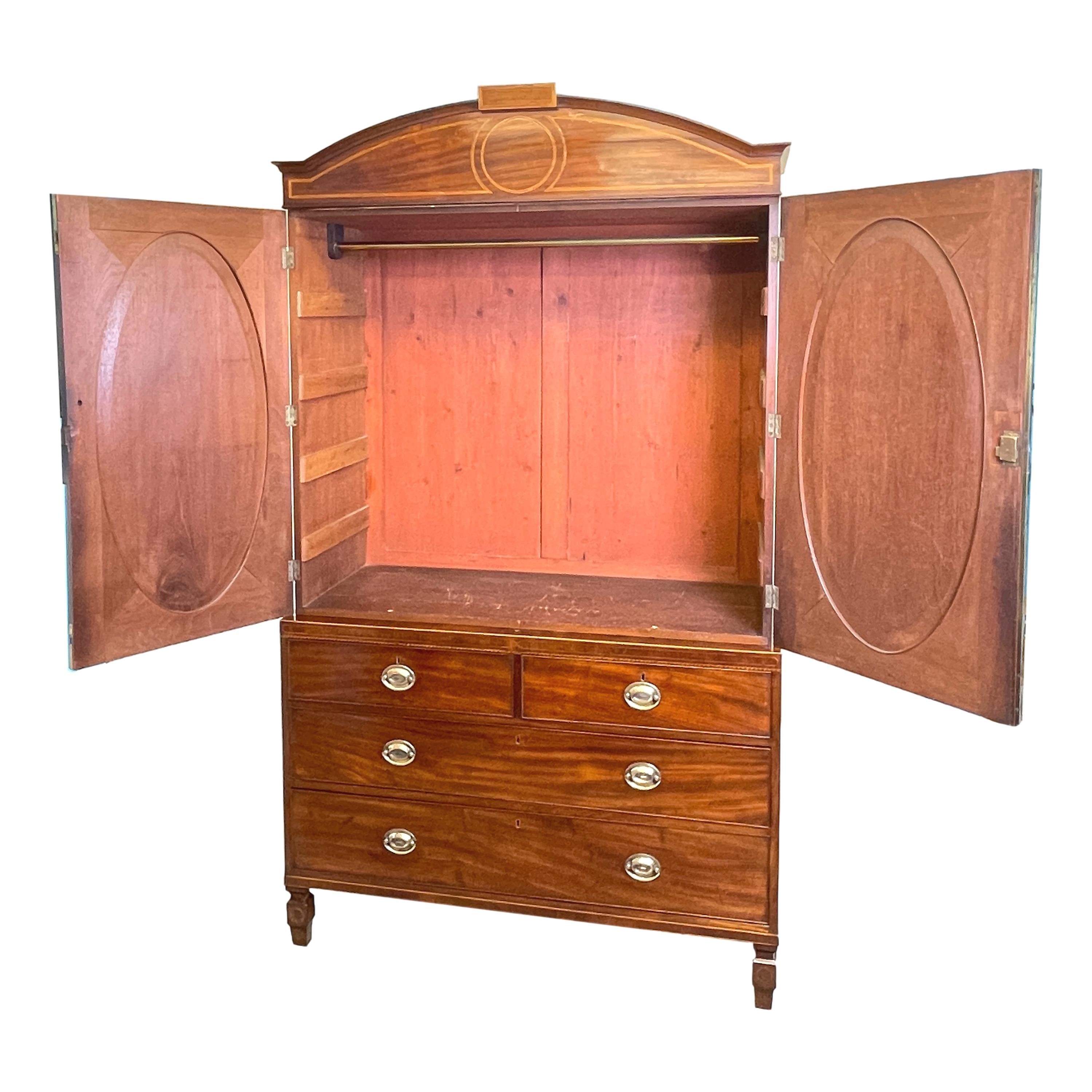 A very fine quality George III period mahogany linen
press having attractive arched cornice over superbly
figured & crossbanded oval paneled doors enclosing
hanging rail above two short and two long drawers
with replacement brass handles raised