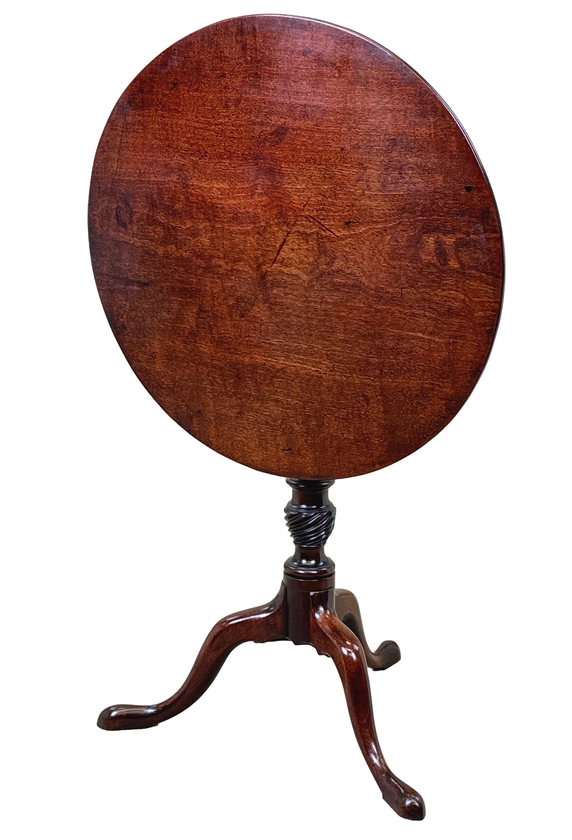 A Good Quality 18th century, Chippendale Period, Georgian Mahogany Wine Table, Or Lamp Table, Having Well Figured Circular Tilting Top, Retainining Exceptional Colour And Patina, Raised On Turned Central Stem With Wrythen Carved Decoration And
