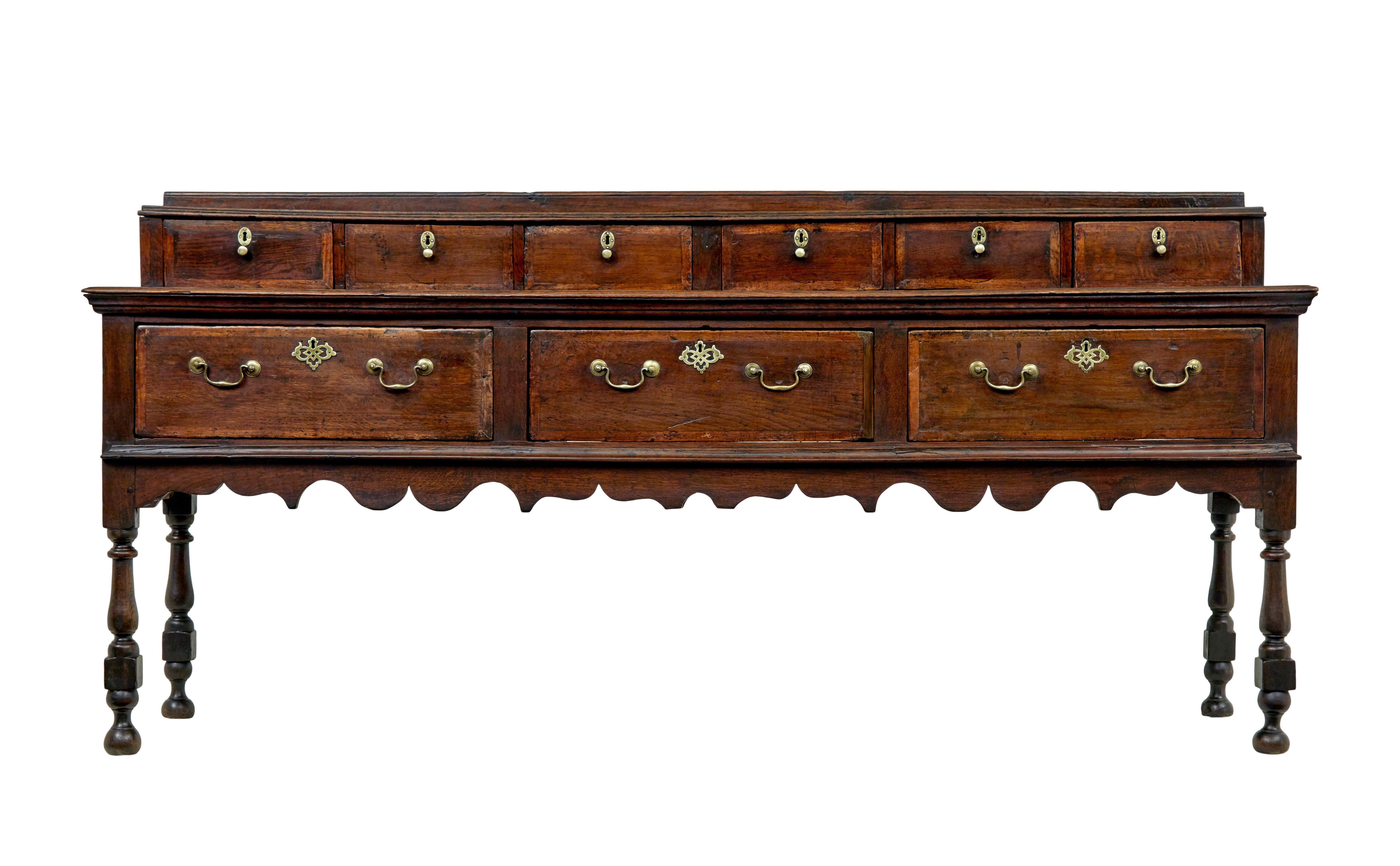Georgian 18th century oak dresser base and spice drawers circa 1750.

We are pleased to offer this dresser which retains it's original spice drawers.

6 spice drawers with cross banded edging, turned brass handles and key plates, original locks but