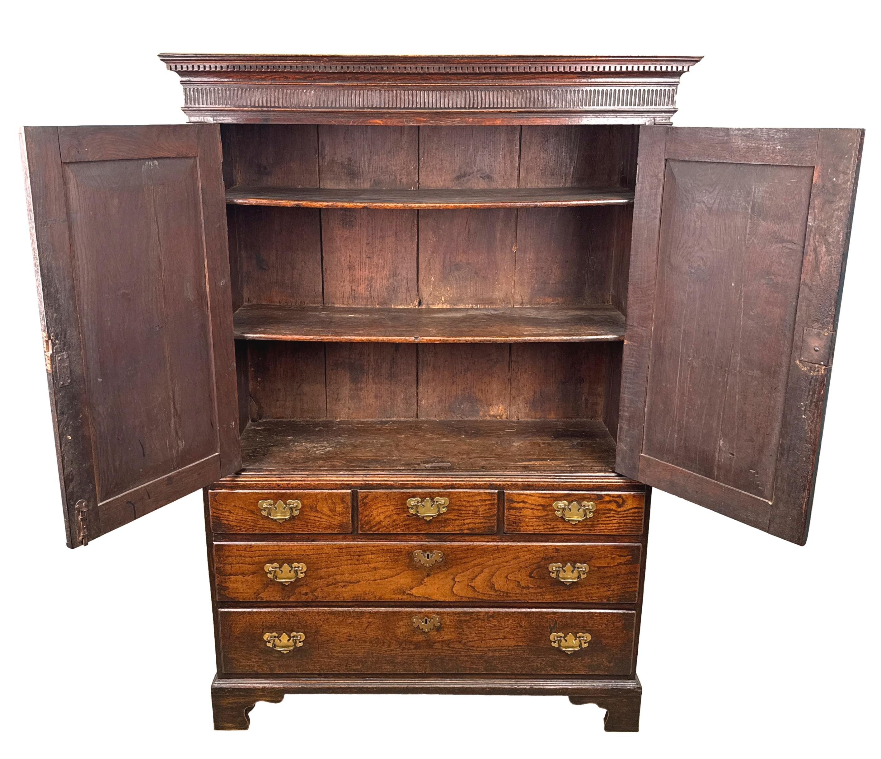 An Extremely Attractive Mid 18th Century George II Period Oak Kitchen Cupboard, Or Linen Press, Retaining Exceptional Untouched Colour And Surface Throughout, Having Matchstick Fluted Carved Decoration And Two Panelled Doors Flanked By Elegant