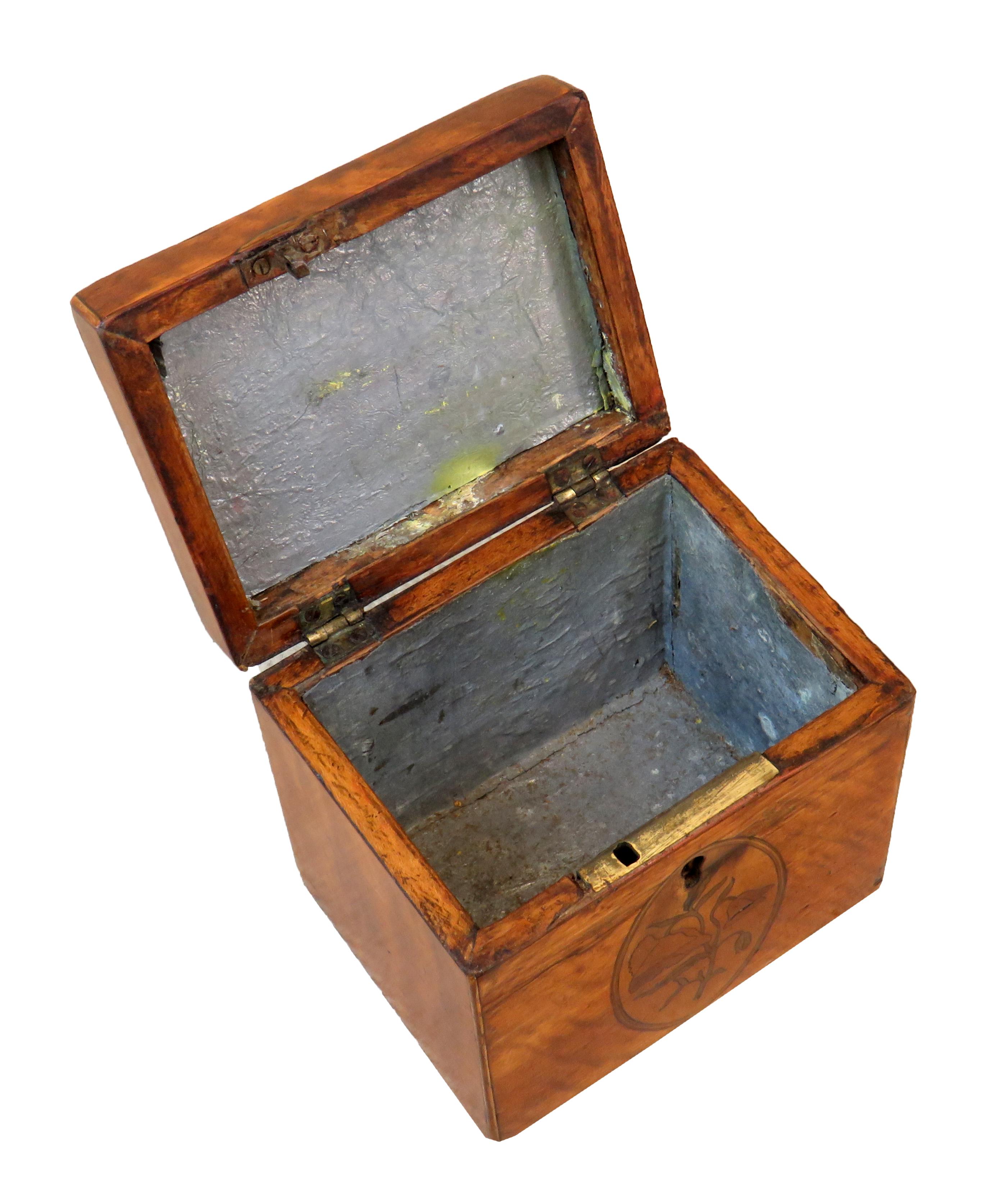 An attractive George III period satinwood oblong tea
caddy having original inlaid decoration and original
foil lined interior.

(Tea was a precious commodity in the 18th century and 
tea caddies were used to both preserve the tea leaves,
but