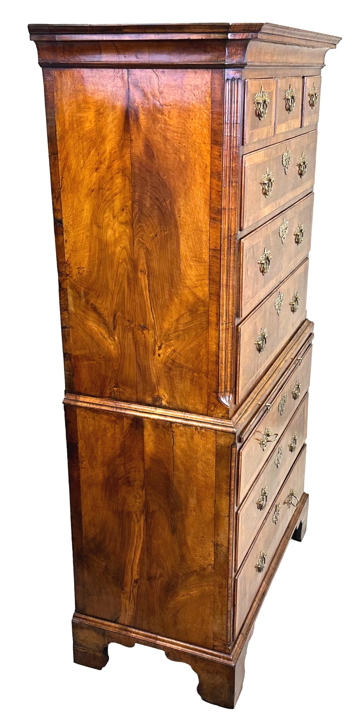 A Fine Quality Early 18th Century, George II Period, Figured Walnut Tallboy, Or Chest On Chest, Having Three Short Drawers Over Six Long Drawers And Panelled Slide, Retaining Original Fretted Brass Plate Handles And Escutcheons, Flanked By Elegant