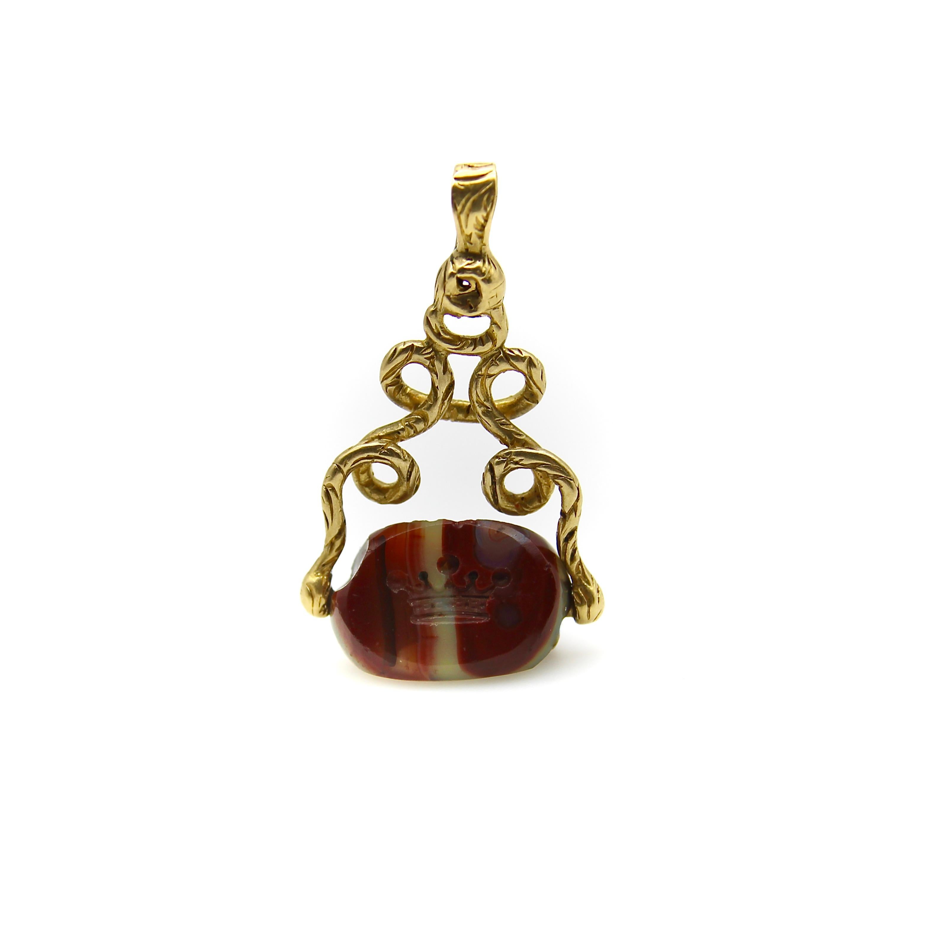 Circa 1800, this incredible Georgian fob is an antique treasure over two centuries old. The three-sided triangular fob is made of banded agate carved with a five-point crown used as a wax seal. The agate is a hue of deep, earthy red marbled with