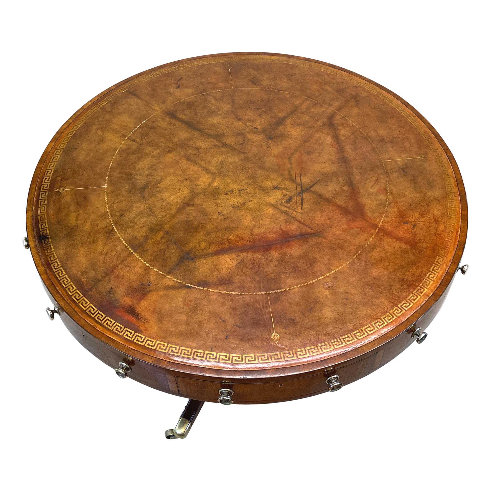 A very good quality late George III/early regency period
mahogany centre standing drum top table having attractive
old gilt tooled leather to circular rotating top over four
frieze drawers alternating with four false drawers raised
on elegant