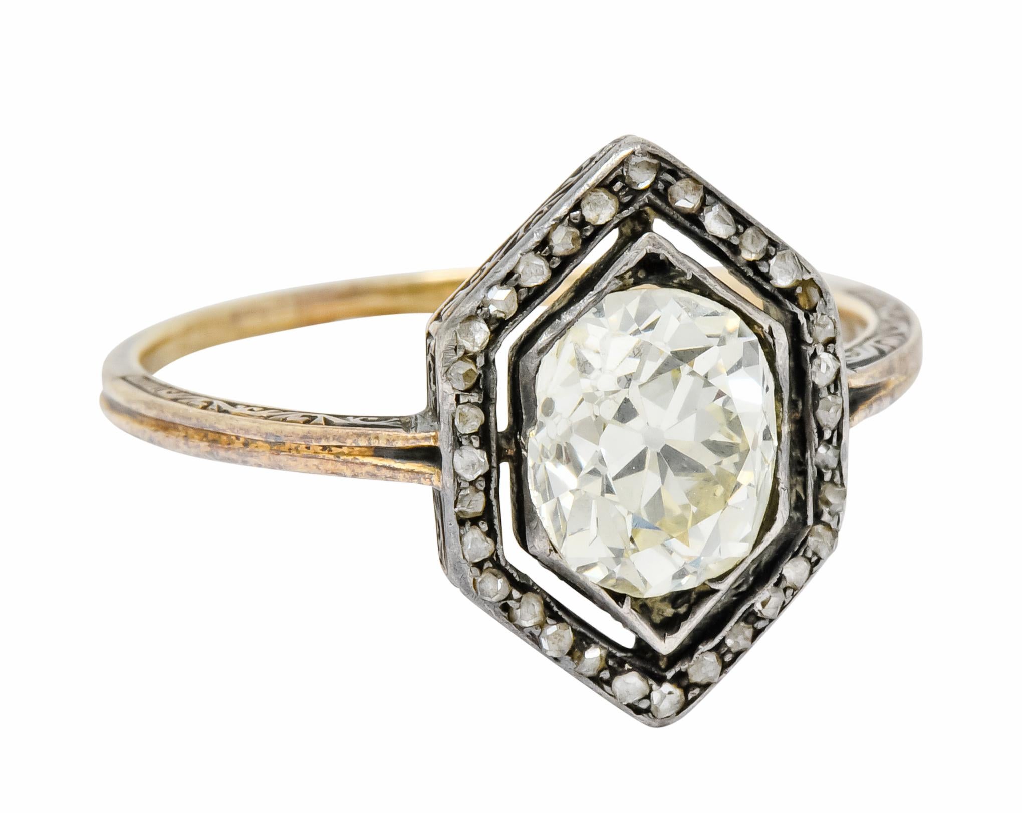 Centering an old mine cut diamond weighing approximately 1.70 carat, P color and VS clarity

Surrounded by halo of rose cut diamonds weighing approximately 0.30 carat total

Set in a tapered hexagonal mounting with a deeply ridged shank 

Accented