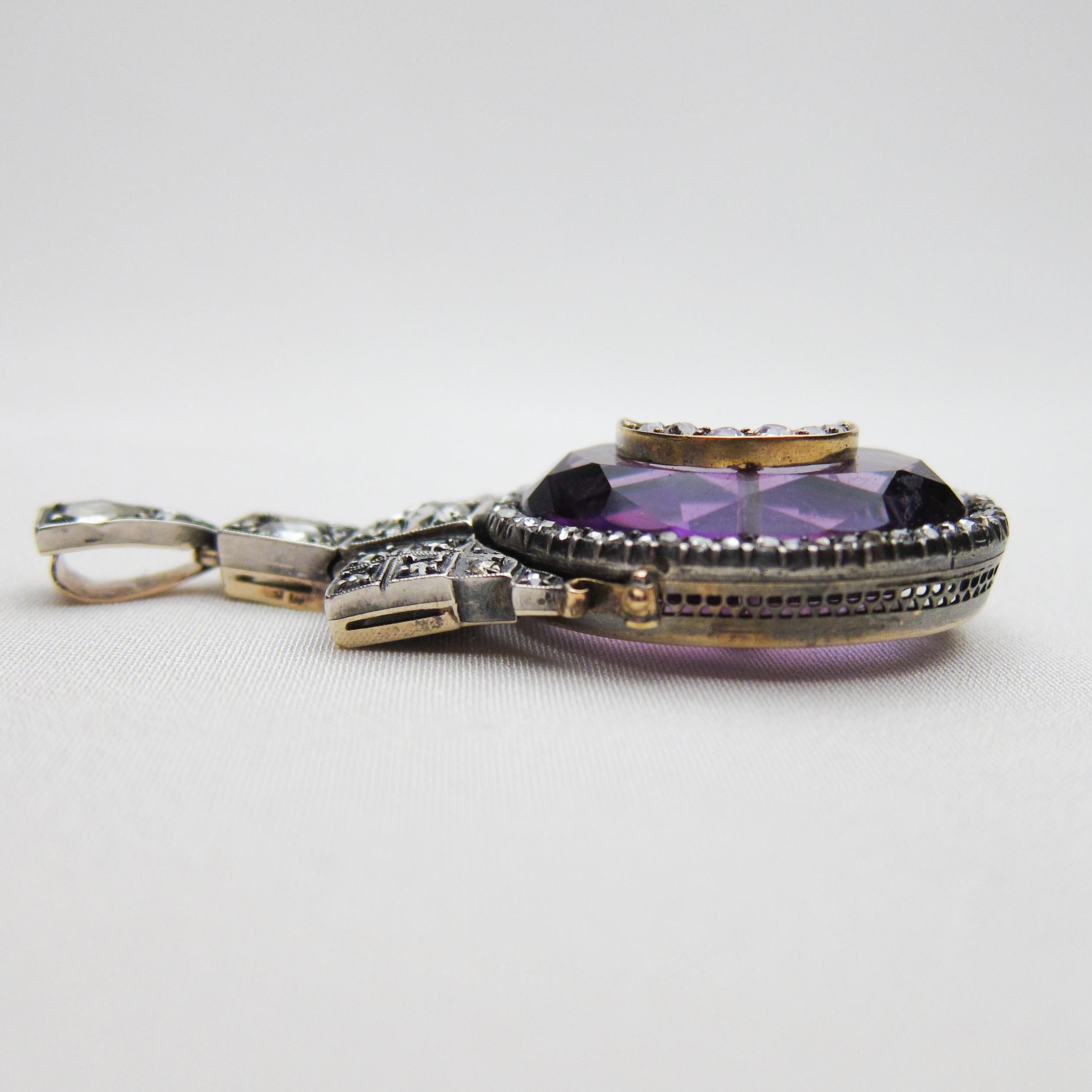 Circa 1850. This gorgeous Georgian pendant features a 29.71 carat mixed-cut natural amethyst set in sterling silver-topped 14KT gold and accented with a diamond crescent moon. The amethyst is surrounded with 52 rose-cut diamonds, while the top of