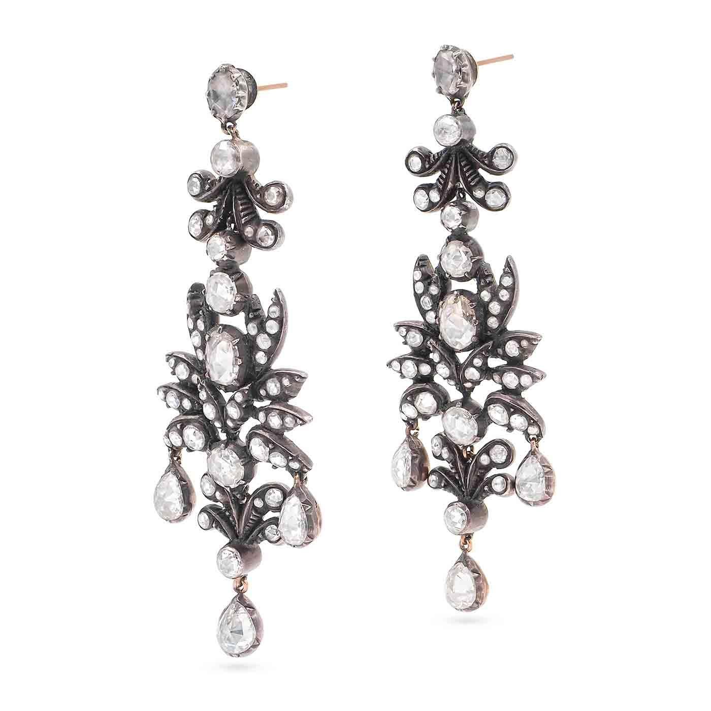 A magnificent pair of Georgian era Rose Cut Diamond Girandole 'Chandelier' Earrings composed of 15k gold and silver. Featuring 106 Rose Cut diamonds weighing approximately 5.50 carats in total -- 6 pear-shaped Rose Cut diamonds weighing