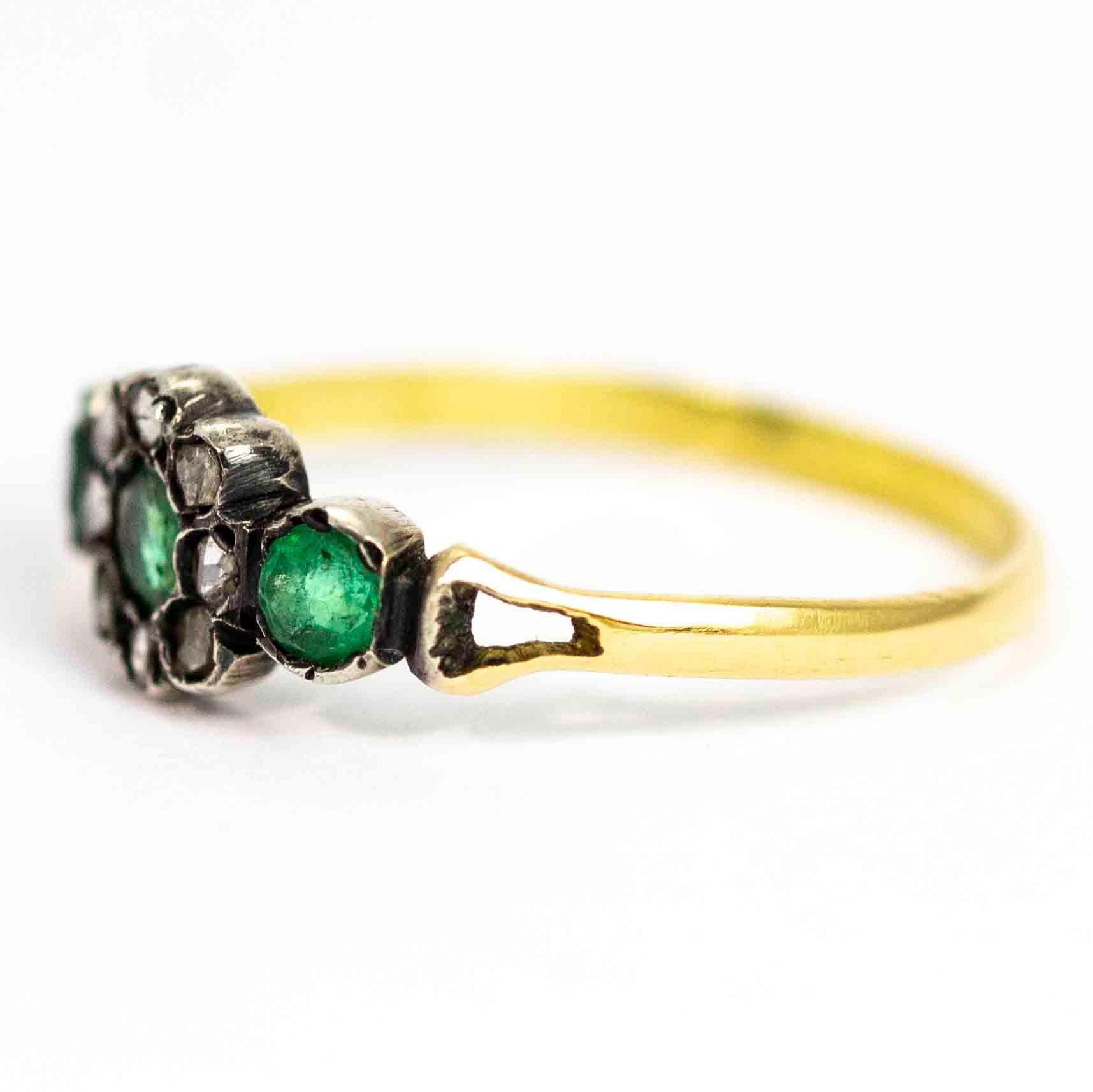 A stunning antique Georgian cluster ring. Set with three beautiful green pastes. The central stone is surrounded by wonderful a halo of eight rose cut diamonds. The stones sit between elegant split shoulders. Modelled in 9 carat yellow gold.

Ring