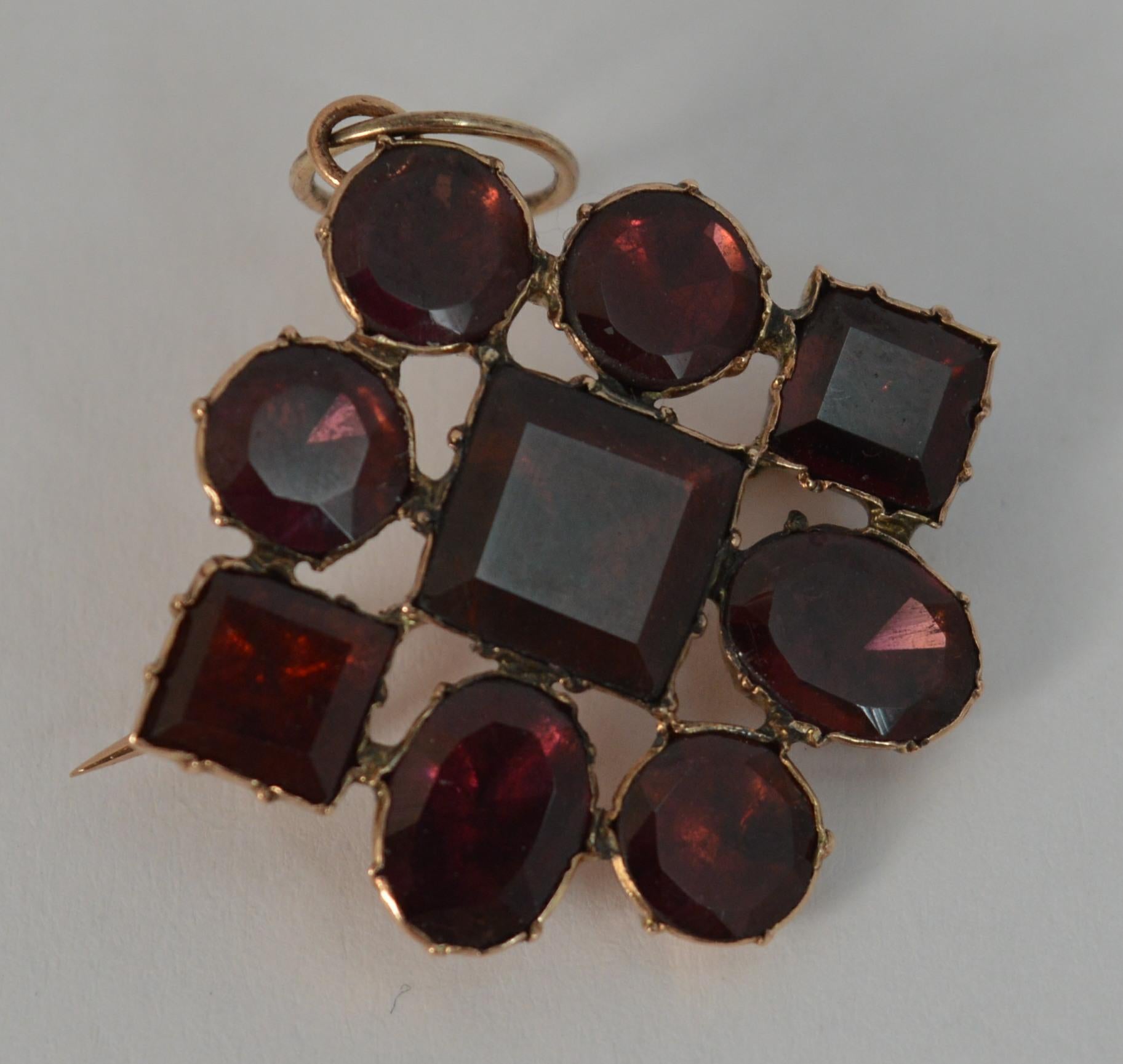 
A rare true Georgian period pendant or brooch circa 1770.

Solid 9 carat rose gold example set with nine natural garnets.

The garnets of square, circular and oval cut of flat cut and in closed foiled backs.


CONDITION ; Excellent. Crisp design.
