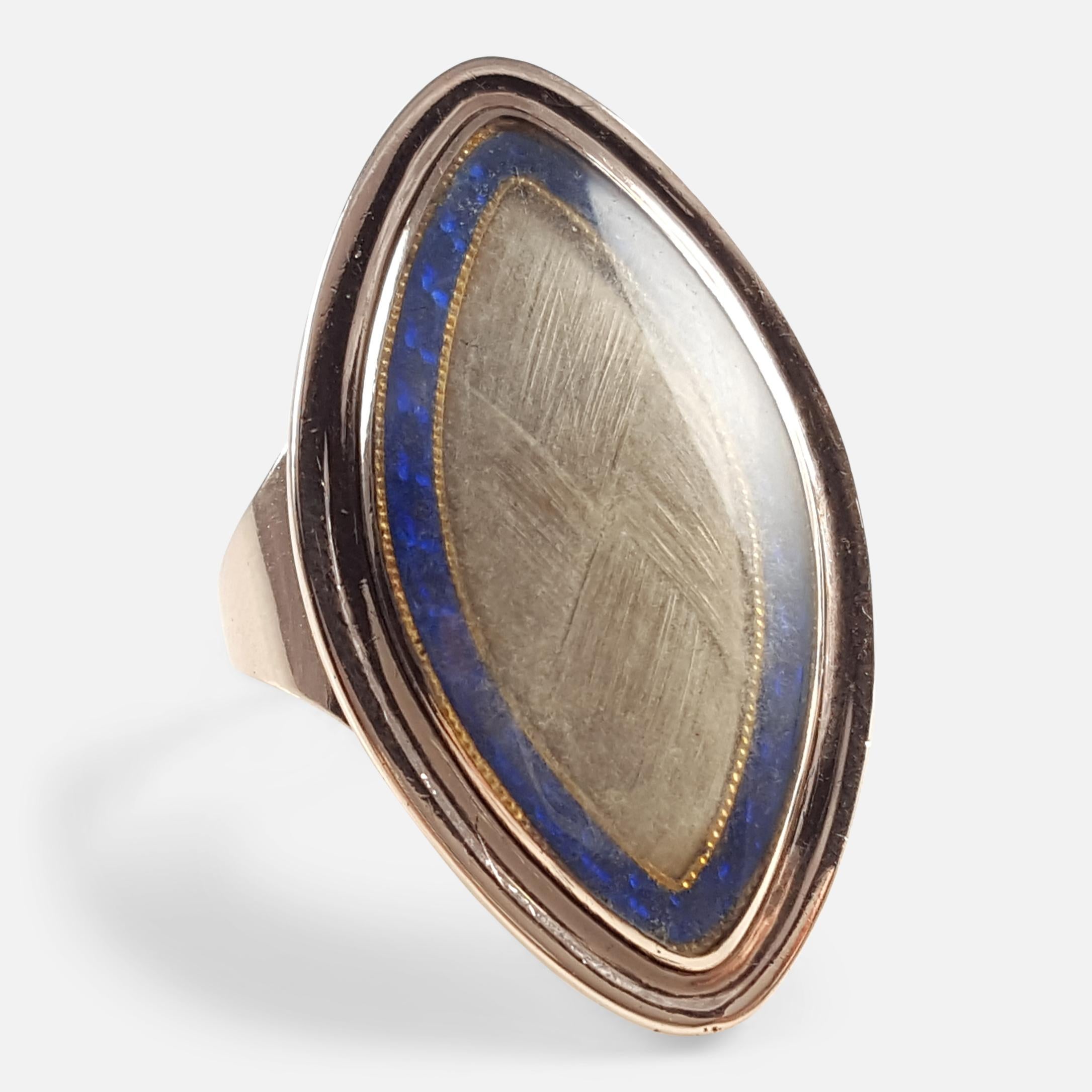 An antique Georgian 9k mellow rose gold glazed hair panel & blue enamel mourning ring circa 1800. The ring is set to the front with a glazed panel containing a woven hair lock surrounded by a blue enamel border to a closed back setting.  As was