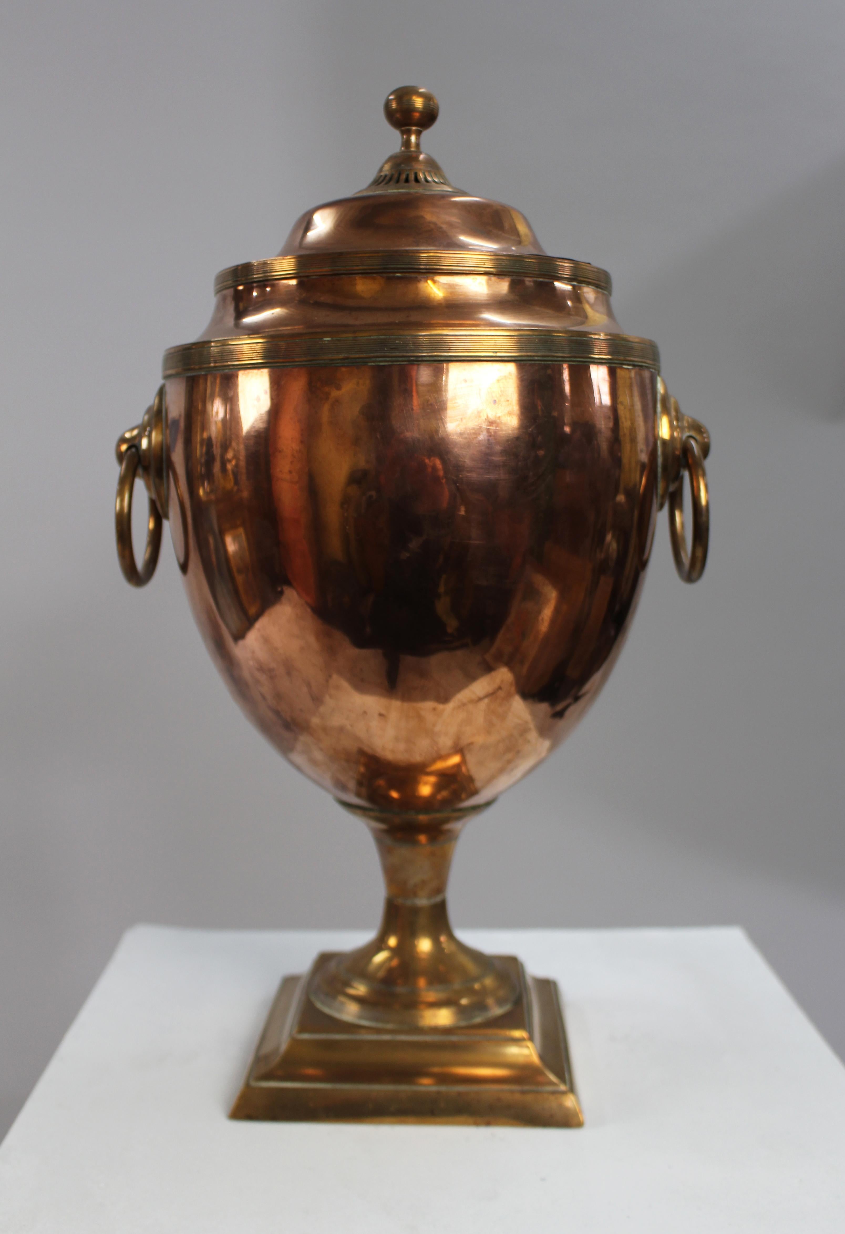 Georgian Adam Style Copper and Brass Samovar, England, circa 1790

An elegant late 18th-century Georgian samovar in the neoclassical Adam style, finely crafted in copper with contrasting brass mounts. The urn-shaped body stands on a stepped square