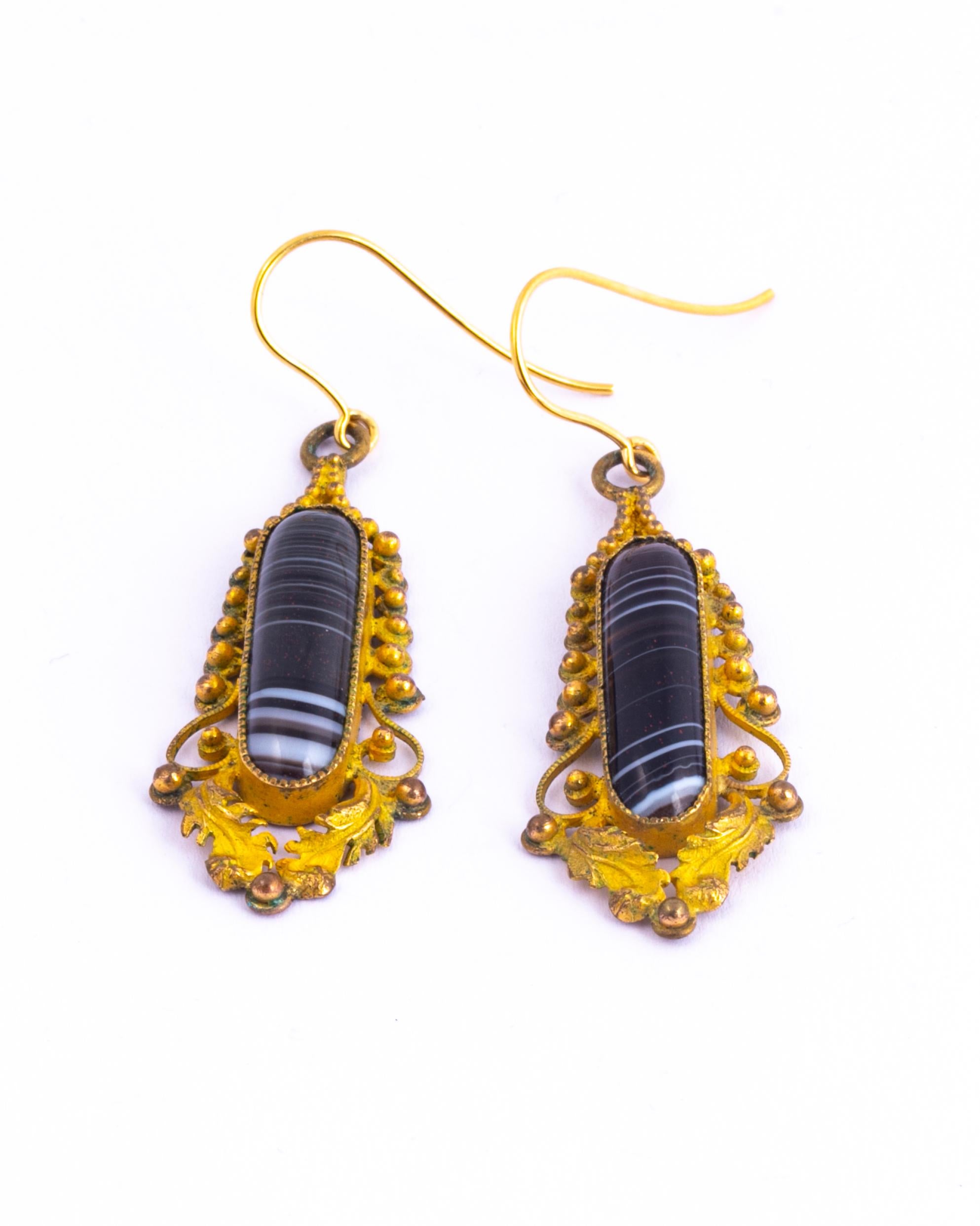 These earrings hold so much detail. The striped stones are encased in a decorative frame with leaf and orb detail. The earrings are worn using shepherds hooks.

Drop From Ear: 50mm 
Stone Dimensions: 22x6mm

Weight: 4.6