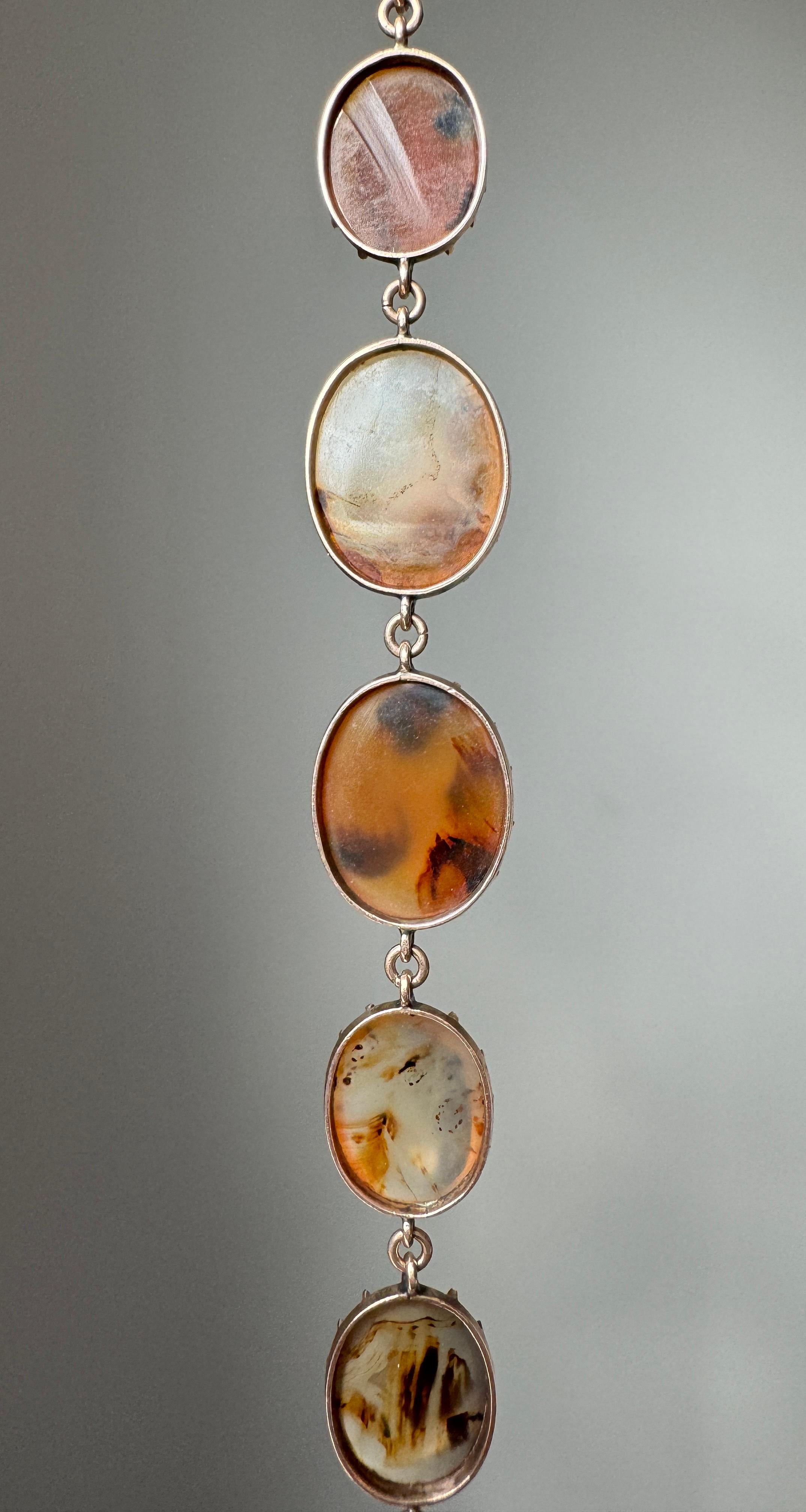 Dating to the early nineteenth century, this Georgian demi-parure gracefully endured the passage of time together. Composed of graduated translucent agate panels mounted in crimped 15 karat rose settings, each terminates in a concealed clasp. A