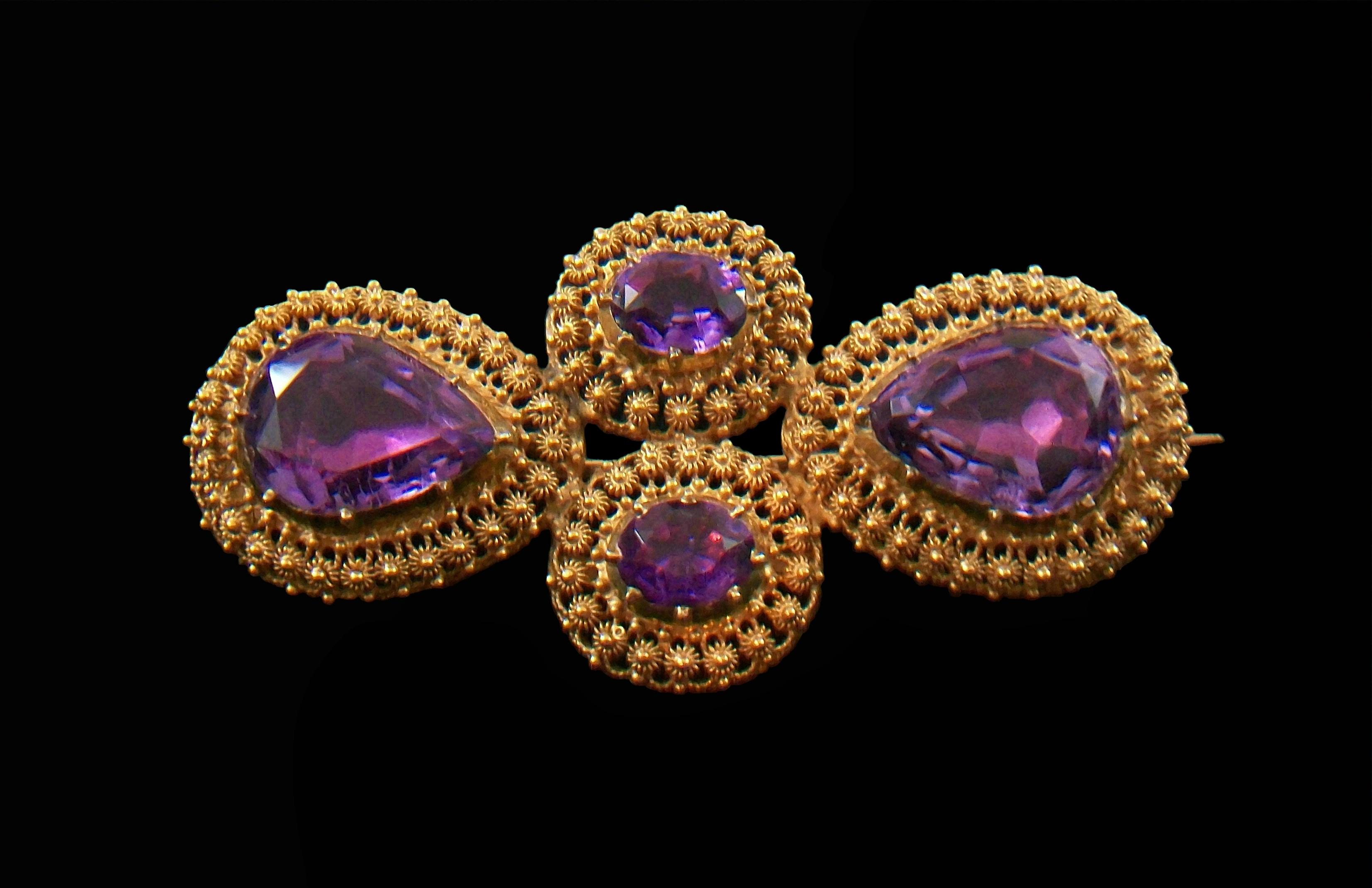 Exceptional Georgian Amethyst and 18K yellow gold cannetille work brooch - featuring four fine crimped collet set and solid gold backed amethyst gemstones (approx. 9.36 Total Carat Weight - each faceted pear shaped gem is 12 mm. long x 10 mm. wide x