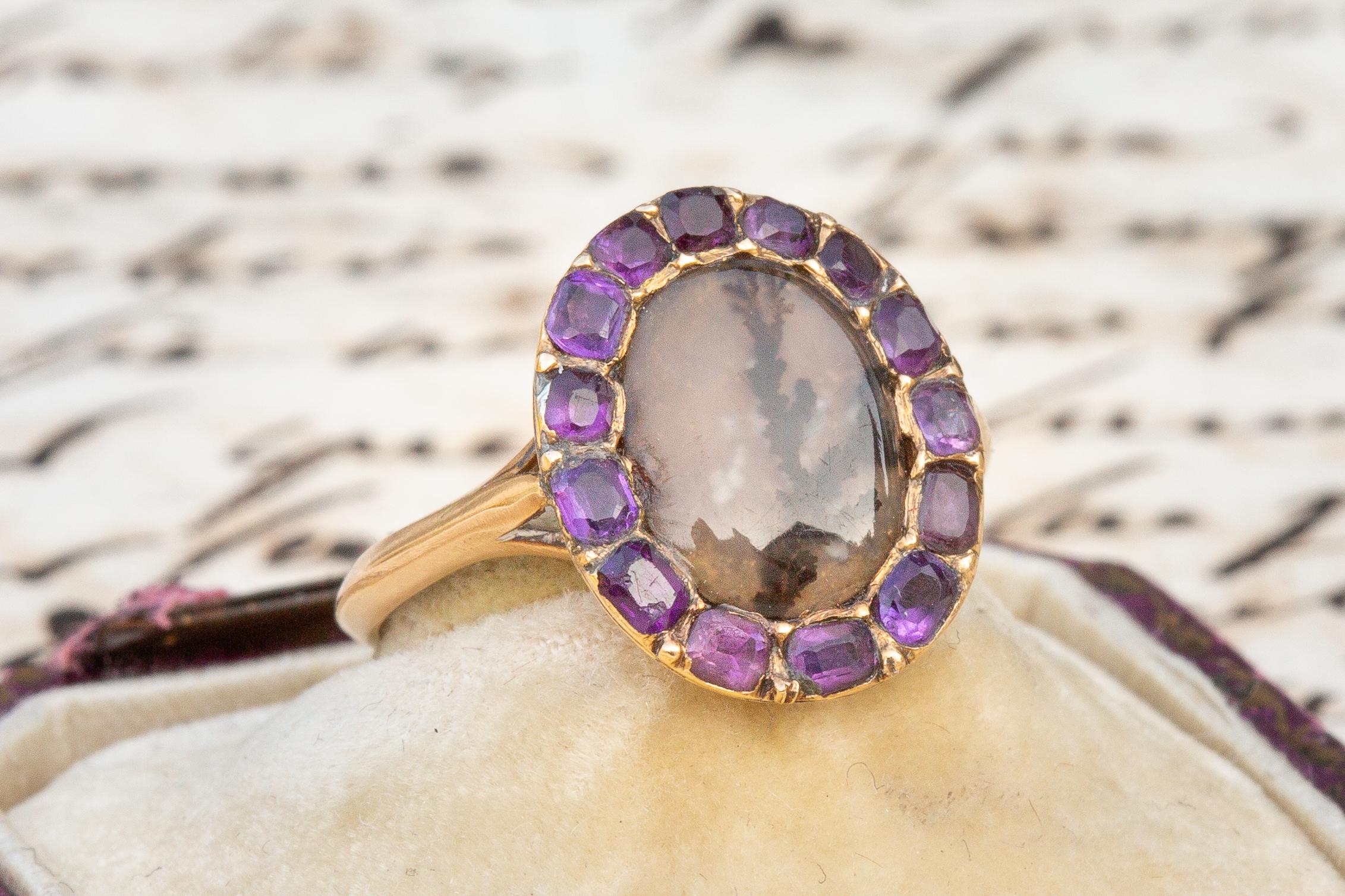 This stunning ring is typical of late 18th century Georgian era cluster rings. In the centre rests a much sought after dendritic agate surrounded by a halo of old cut amethysts. This seemingly perfect combination of gemstones was quite uncommon at